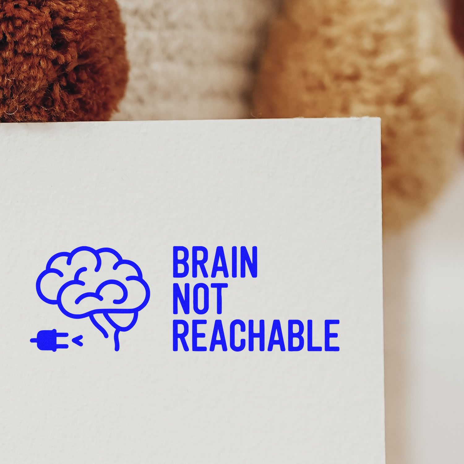 Blue brain icon stamp and seal on white paper reading BRAIN NOT REACHABLE