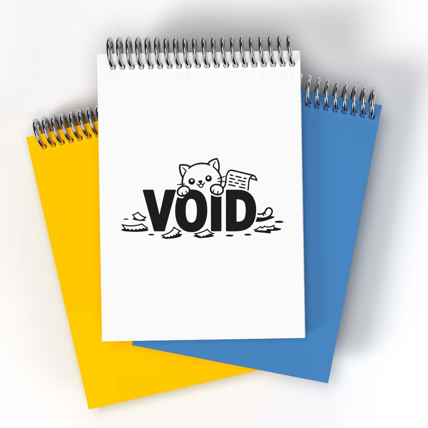 VOID stamp seal on white spiral notebook, layered over yellow and blue spiral notepads