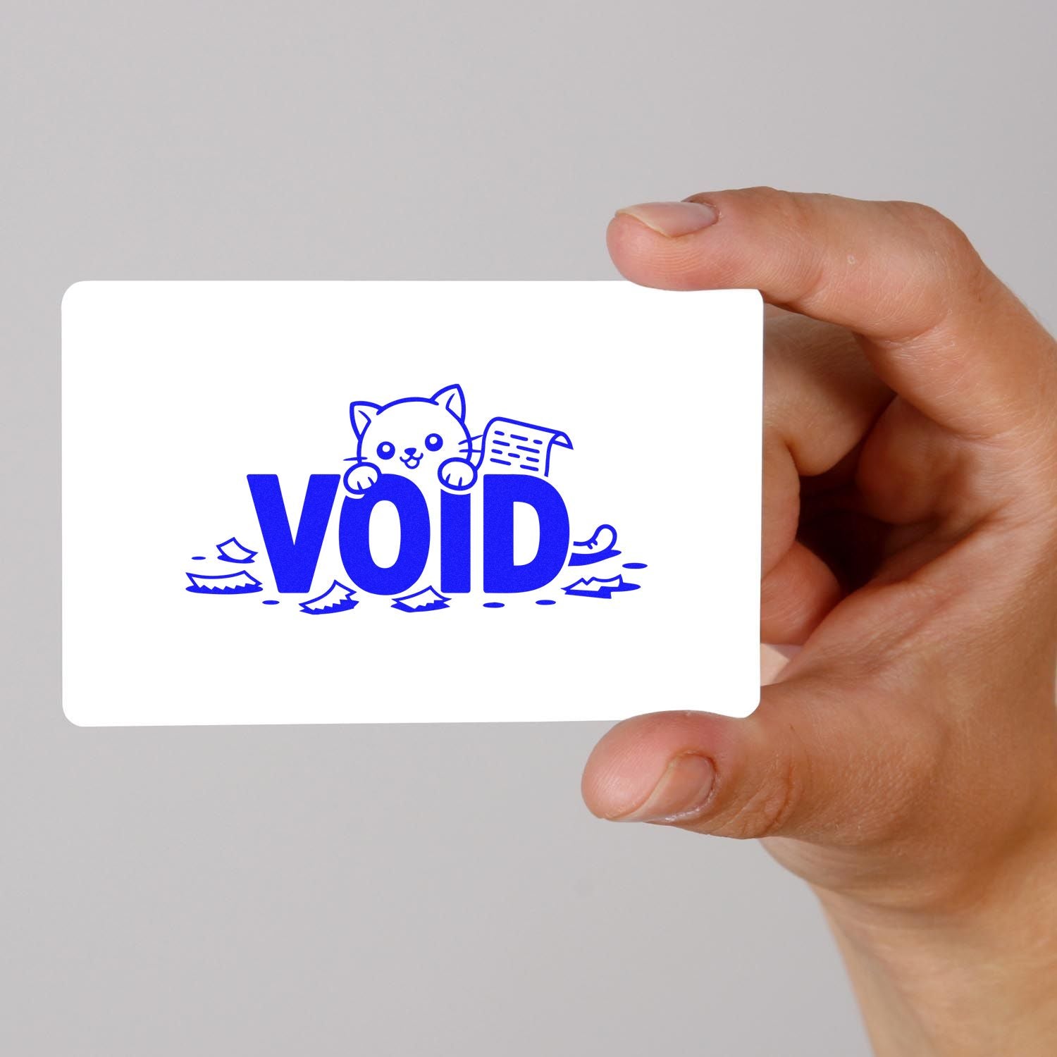 Hand holding white VOID security seal card with blue cat stamp and torn-paper accents.