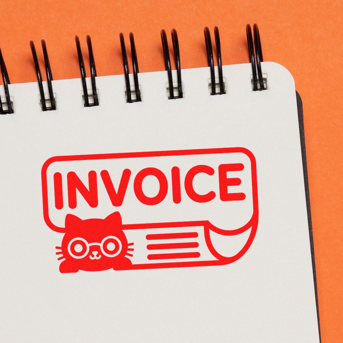Red invoice stamp seal with cat icon on a white spiral notebook against an orange background.