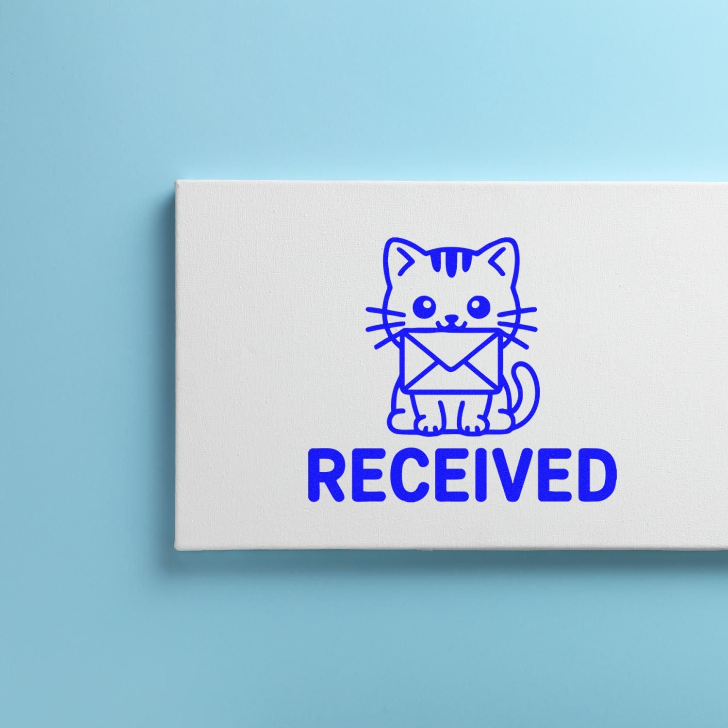 Blue RECEIVED stamp/seal with cat holding envelope on white block, on light blue background.