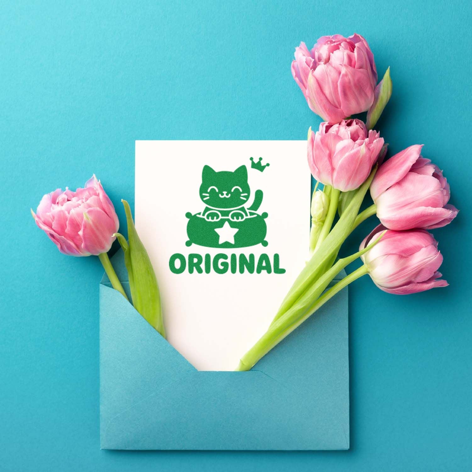 Green cat ORIGINAL stamp on white card in blue envelope, framed by pink tulips on turquoise background.
