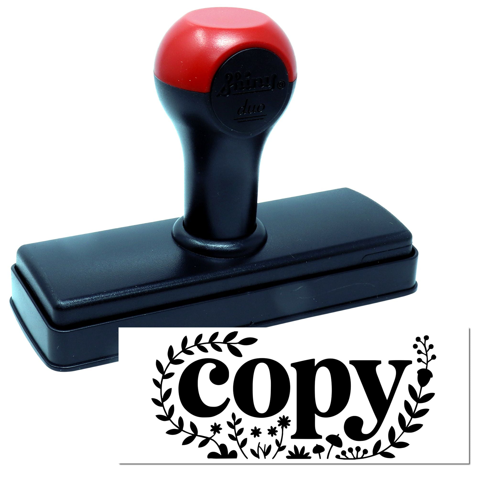 Red and black self-inking stamp and seal featuring a decorative floral copy imprint