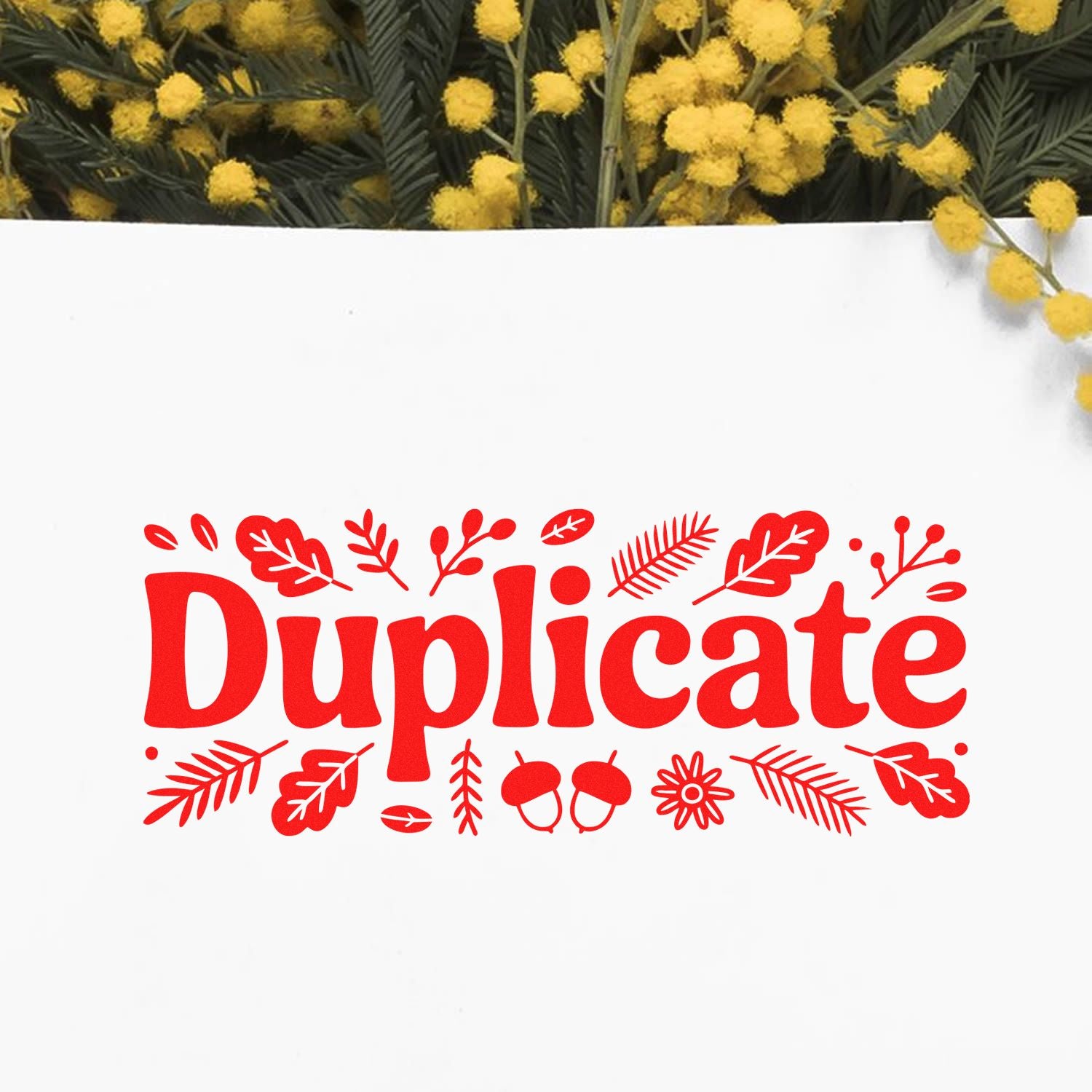 Red Duplicate stamp seal with leaf, acorn and flower accents on white, framed by yellow mimosa blossoms.