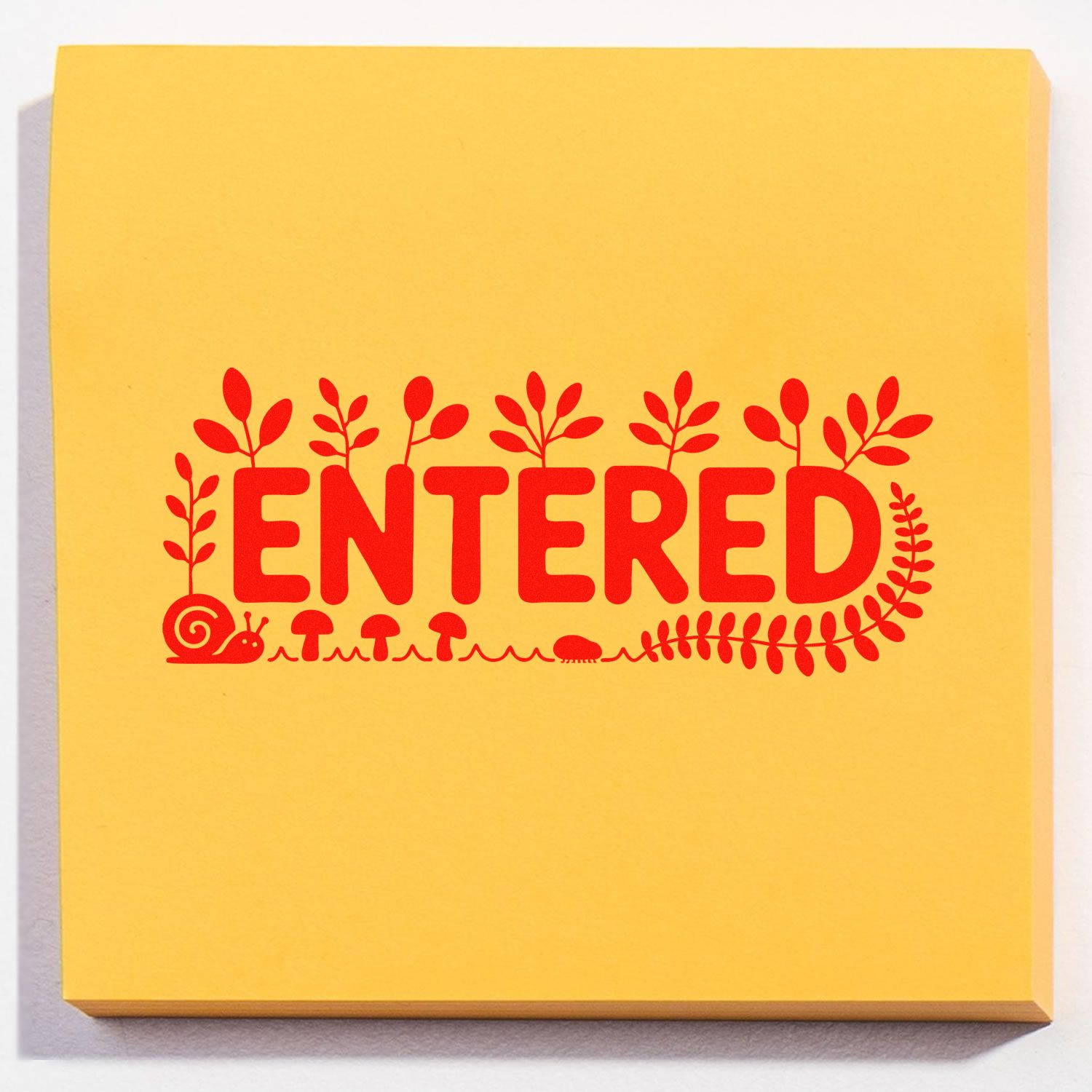 Yellow stamp-and-seal pad with bold red ENTERED lettering, leafy border, mushrooms and a snail motif.