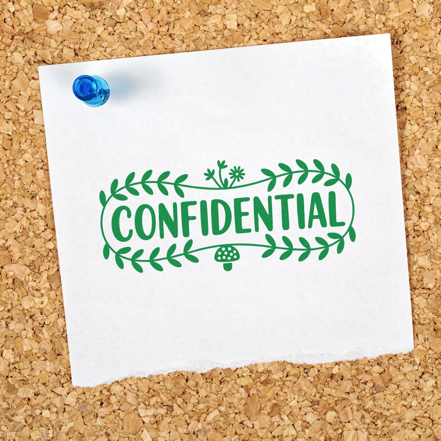 Green CONFIDENTIAL stamp seal with leafy border on white paper, pinned by blue tack on corkboard.