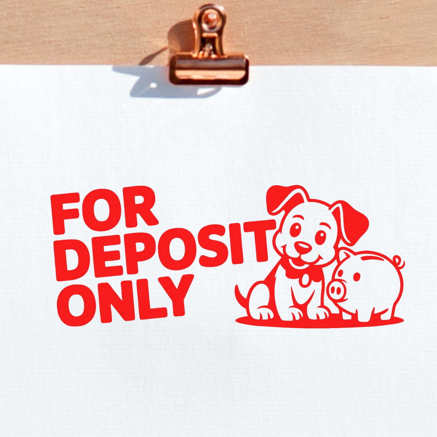 Red bank deposit stamp and seal with dog and piggy bank design on white paper clipped to a copper clipboard.
