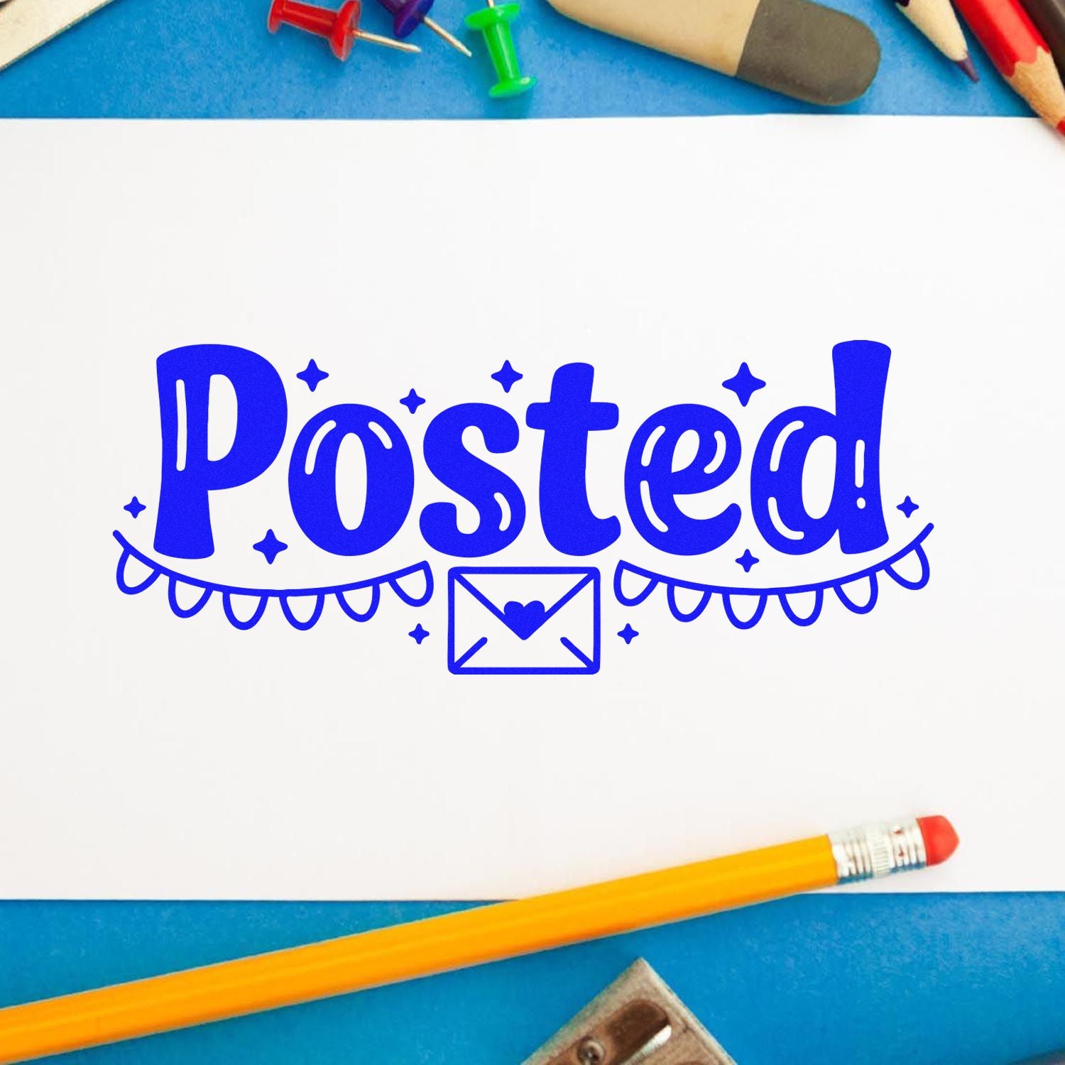 Blue Posted stamp seal with envelope icon on white paper, framed by pencils and push pins.
