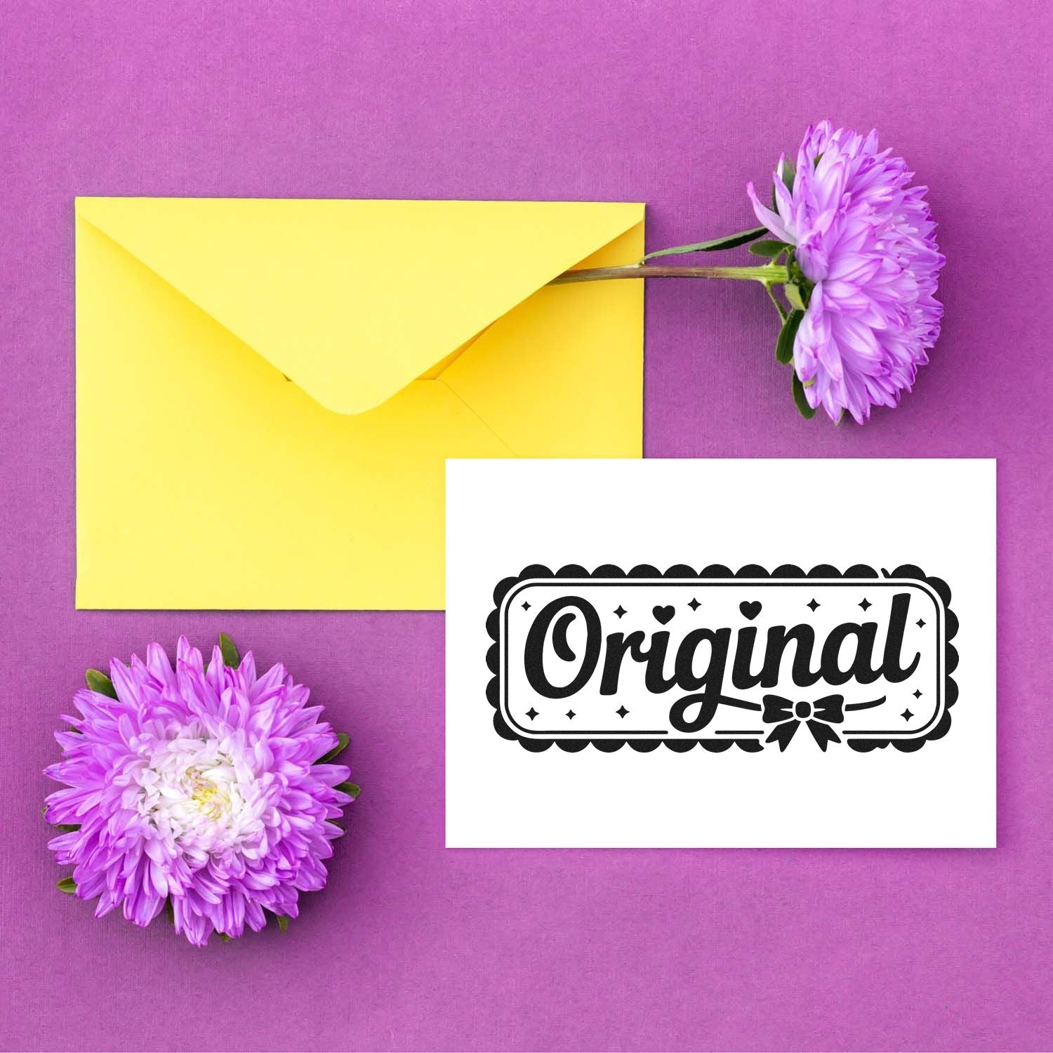 Yellow envelope and purple flowers beside a white card with black ornamental Original stamp seal on a purple background.