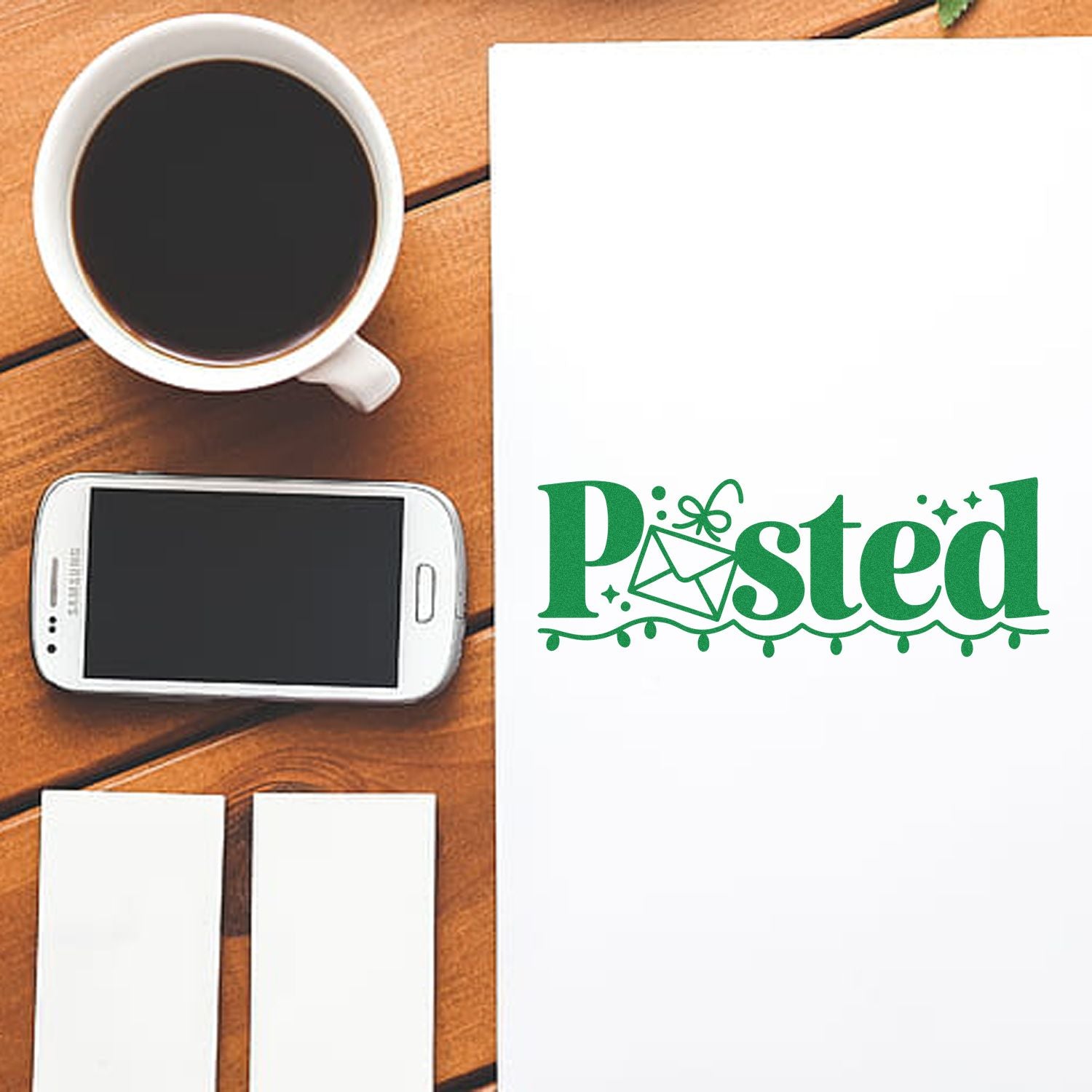 Green Posted stamp seal on white paper beside coffee cup, smartphone, and blank cards on a wooden desk.