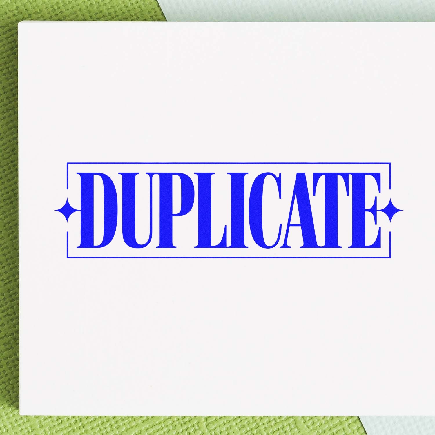 Blue DUPLICATE stamp and seal on a white card, framed by a thin border, against a green textured background.