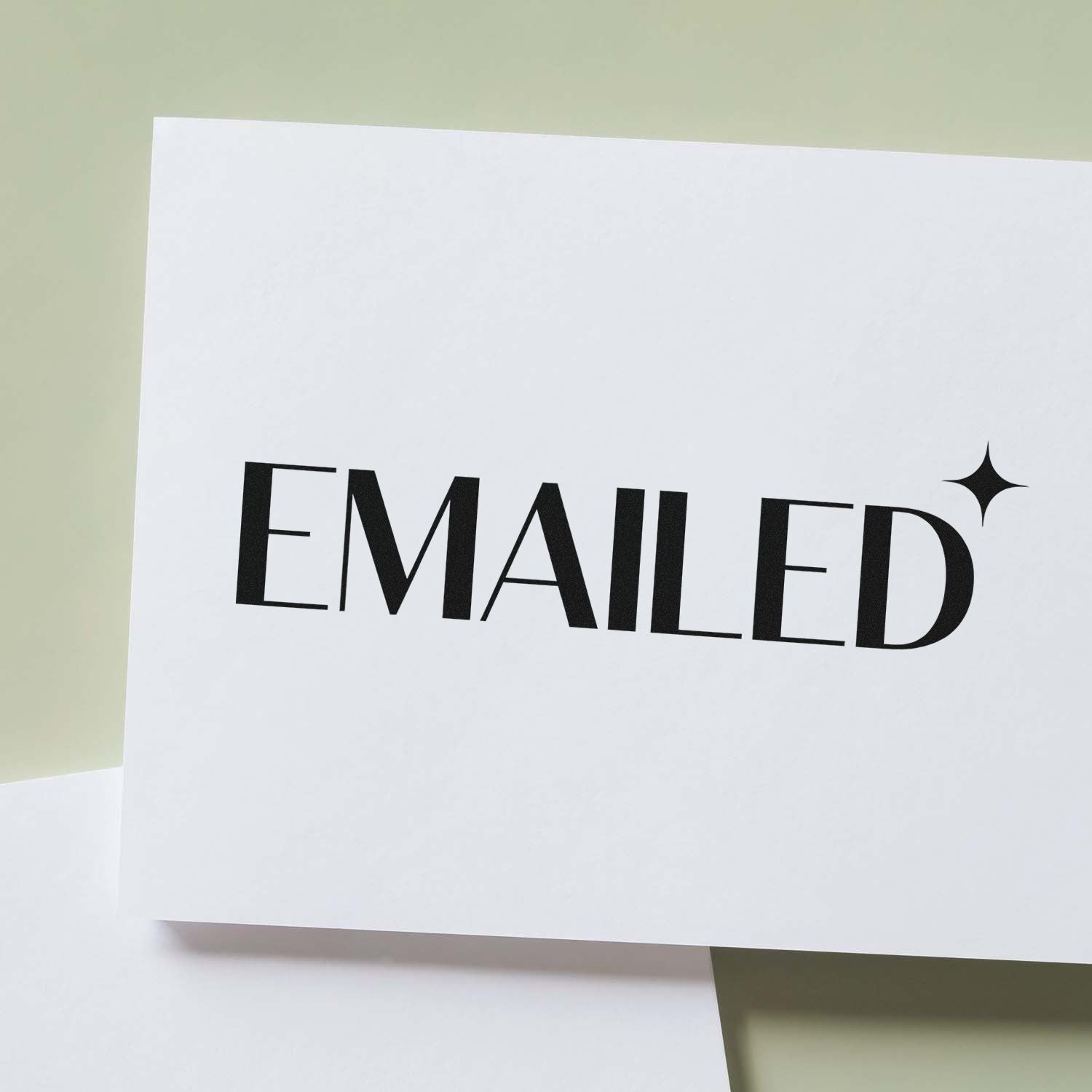 Black EMAILED stamp and seal on white card with sparkle icon, set against a pale green background.