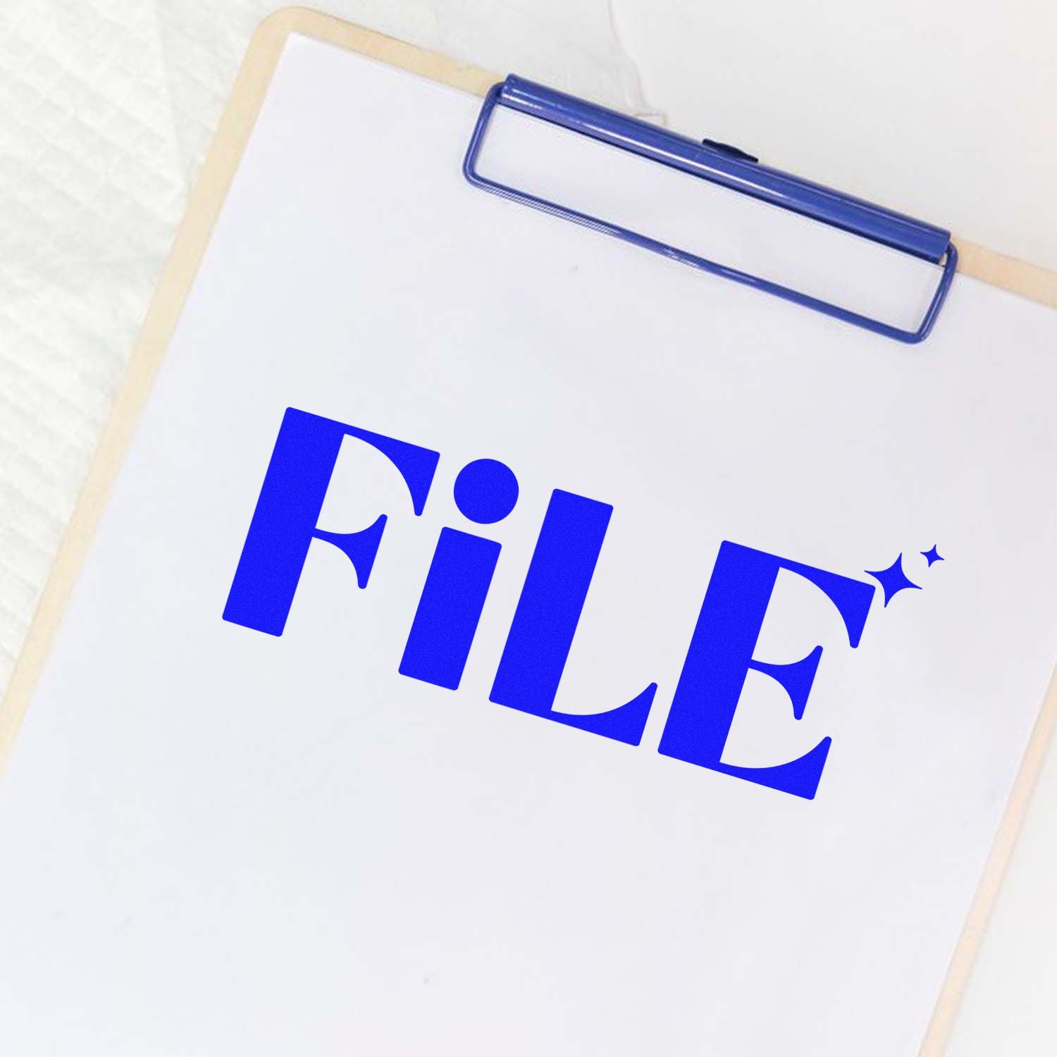 Blue FILE stamp on white paper clipped to a beige clipboard, featuring an office stamp and seal-style design.