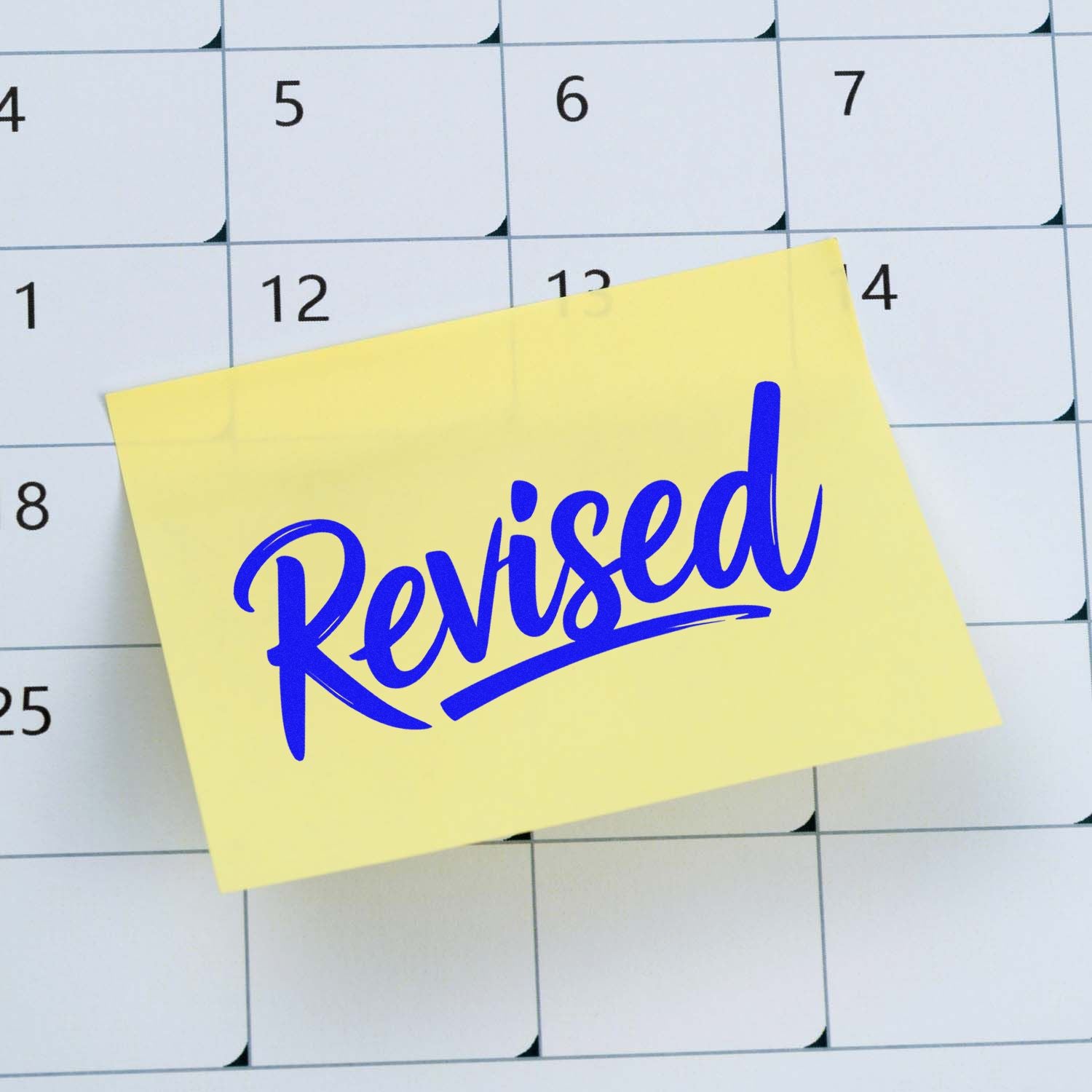 Blue Revised stamp seal on a yellow sticky note over a calendar grid.