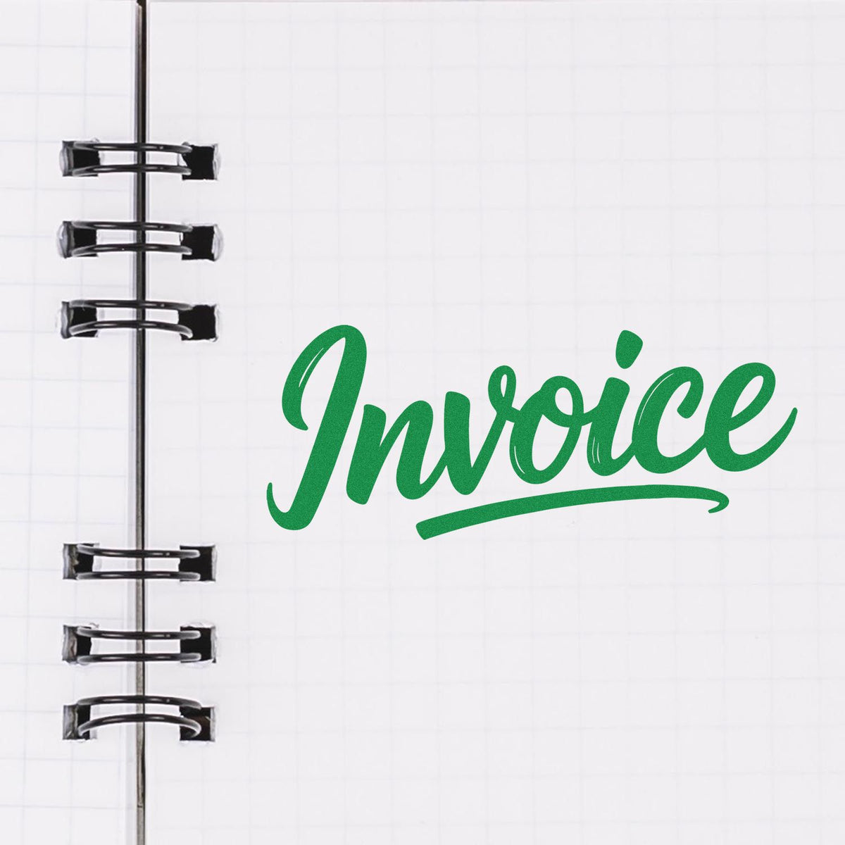 Green Invoice stamp on a white spiral notebook page with black ring binding, featuring custom stamp and seal design.