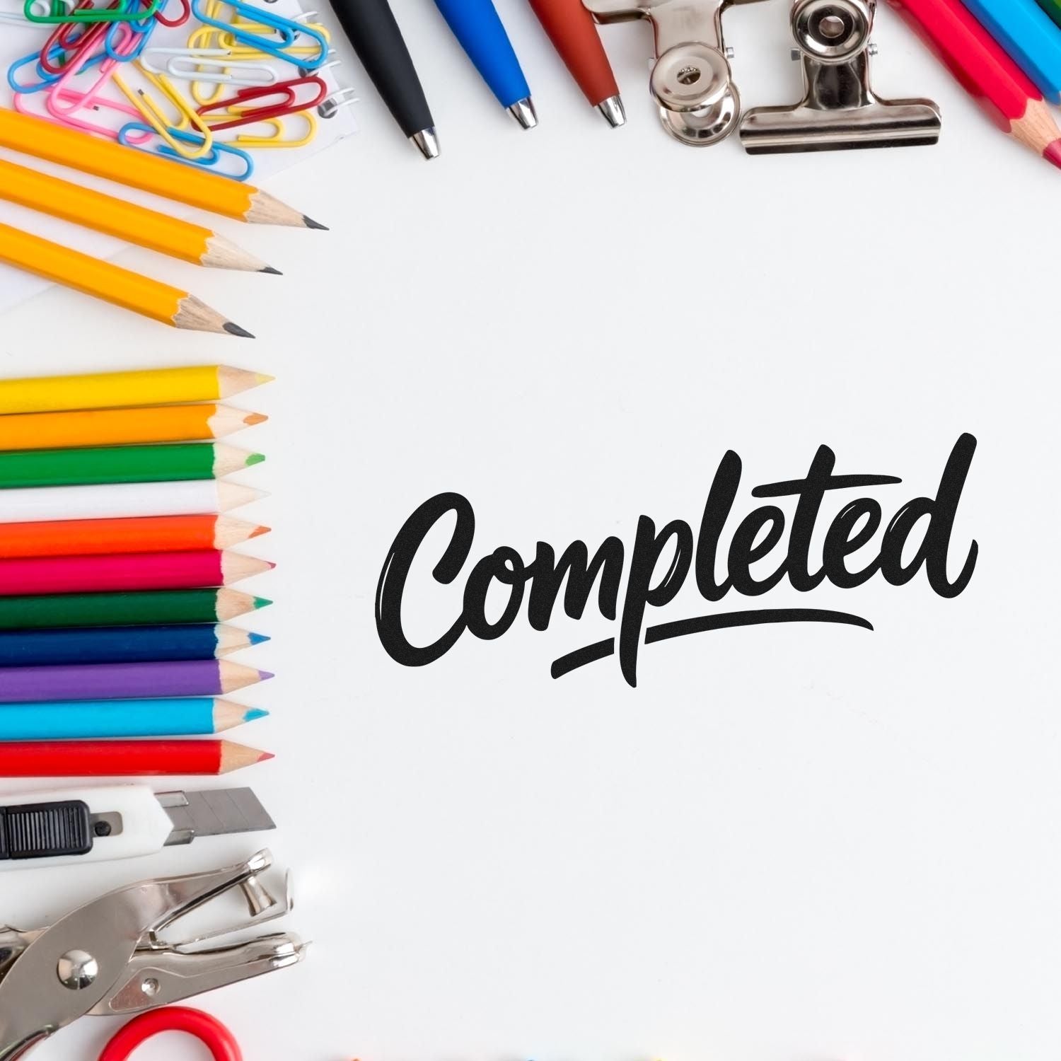 Black Completed stamp with colorful pencils, pens, paper clips, and metal stamp-and-seal tools on white.