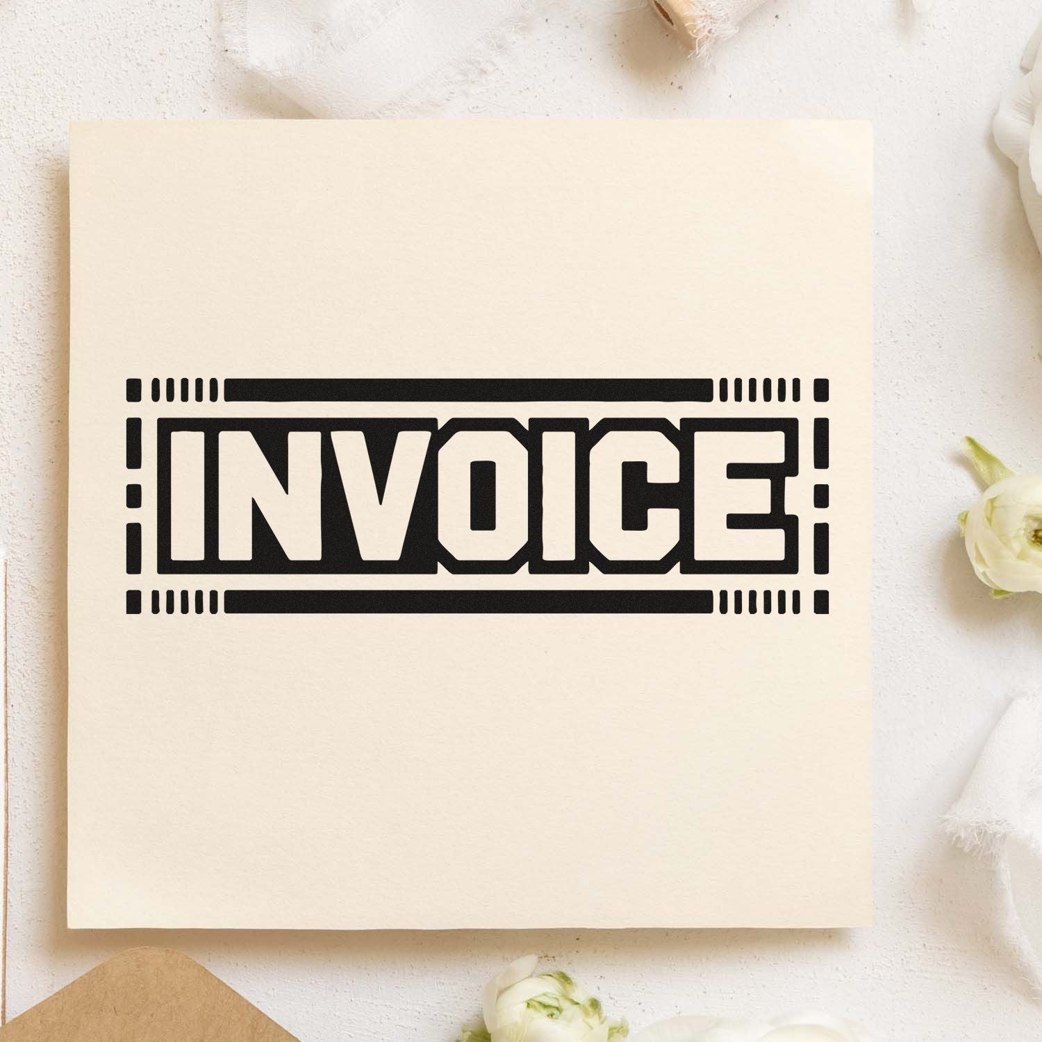 Black INVOICE stamp seal with bold border on cream paper, ideal for document or packaging branding.