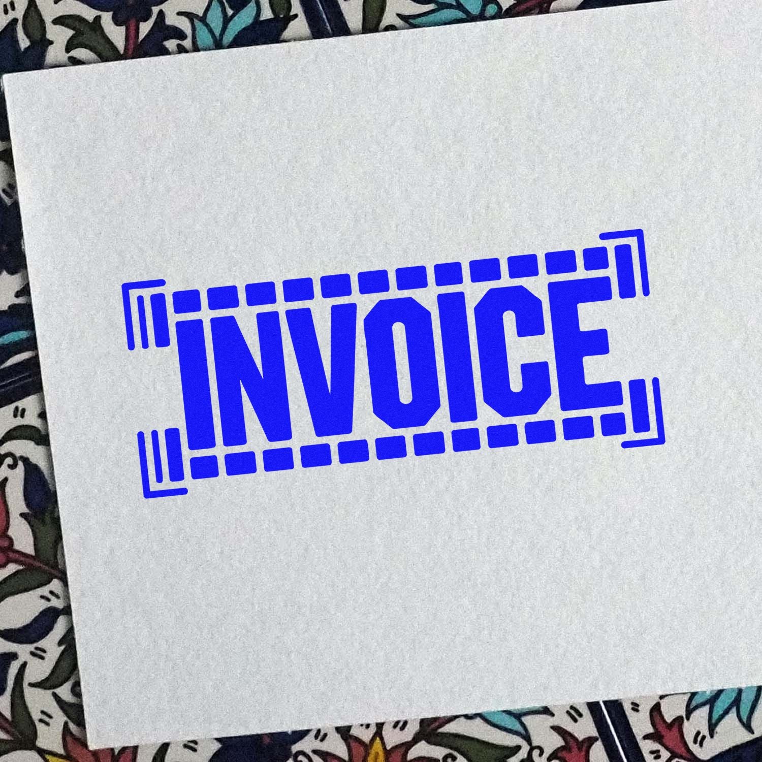 Blue invoice stamp seal in bold block letters, framed by a rectangular border on white paper.