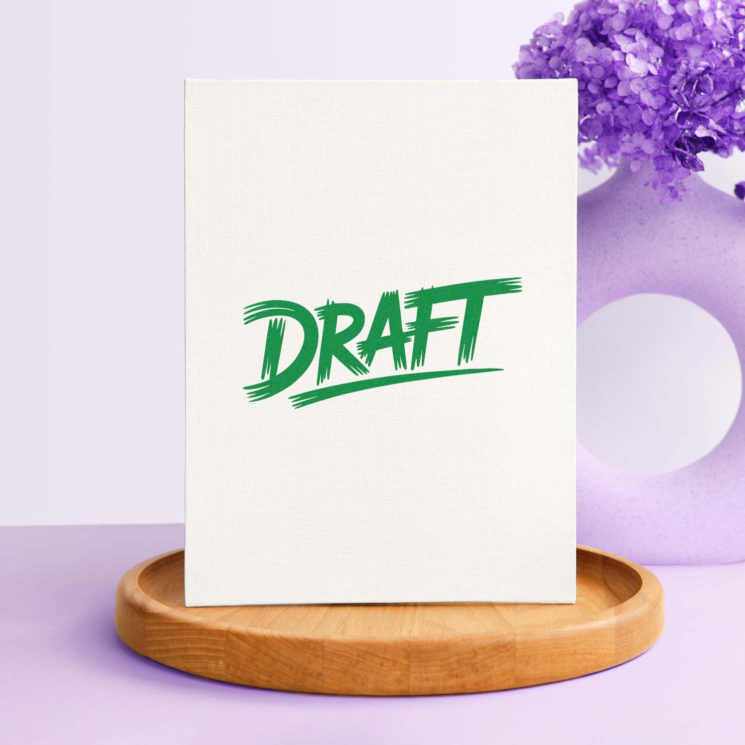 Green DRAFT stamp and seal on white card, set on a wooden base against a purple floral background.