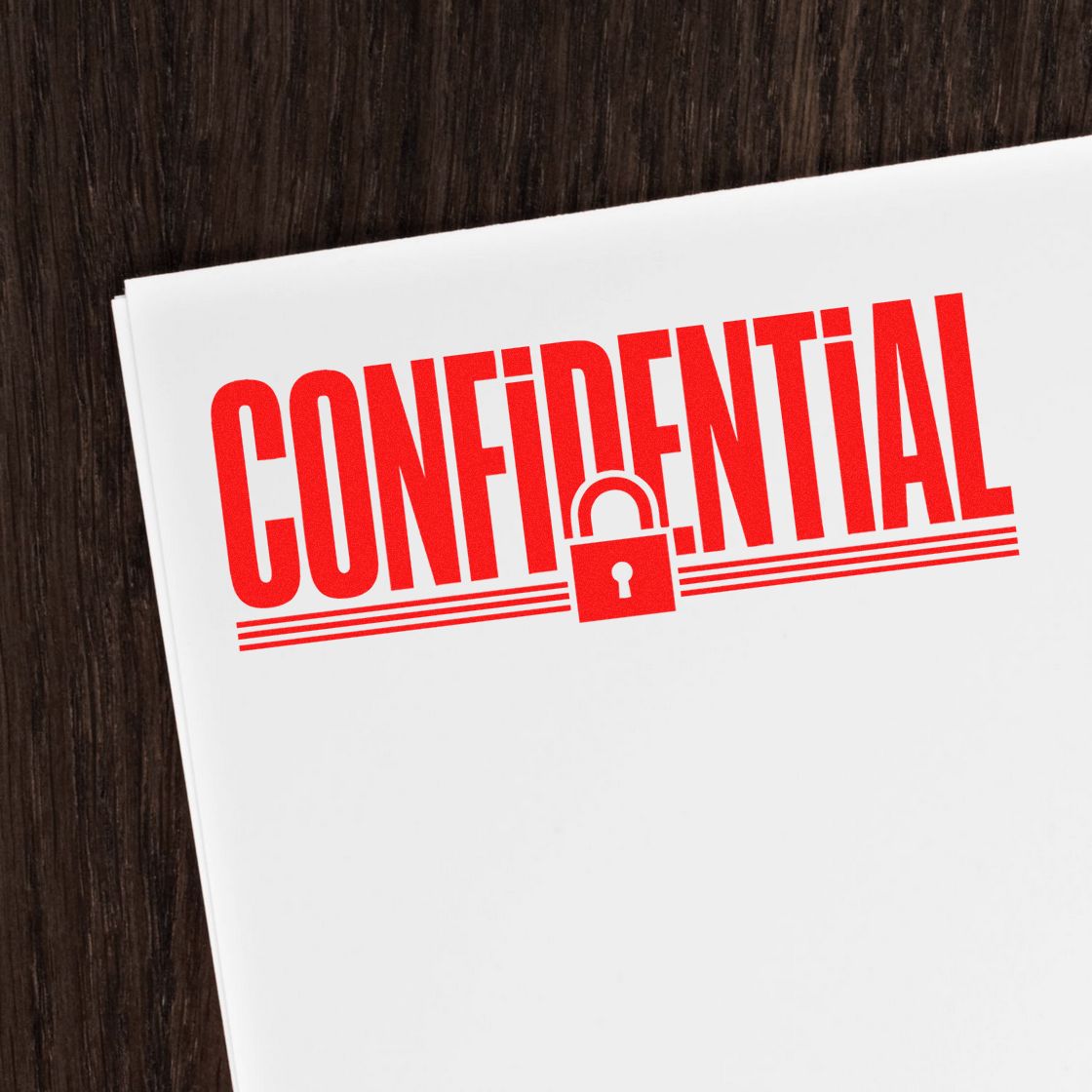 Red confidential stamp and padlock seal on white paper over dark wood desk.