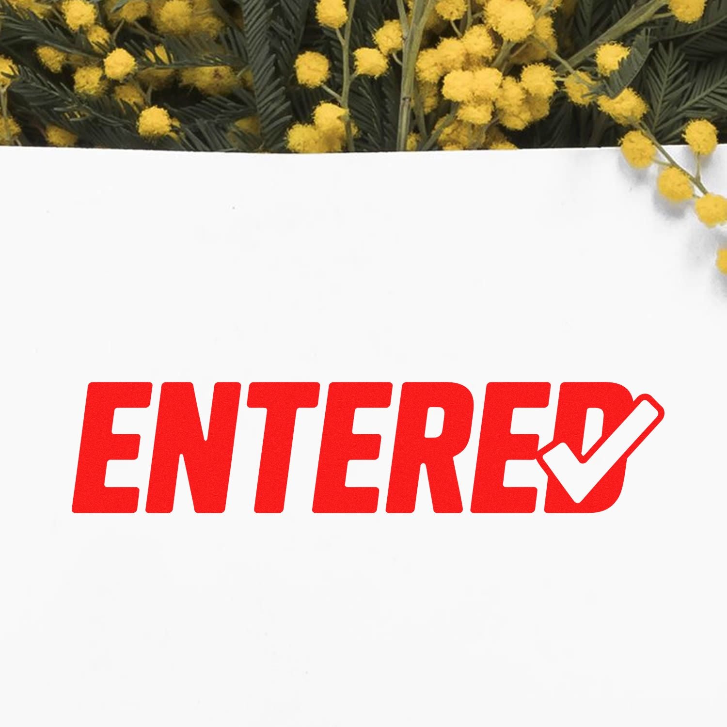 Red ENTERED approval stamp with white checkmark on white background, framed by yellow flowers and dark green foliage.