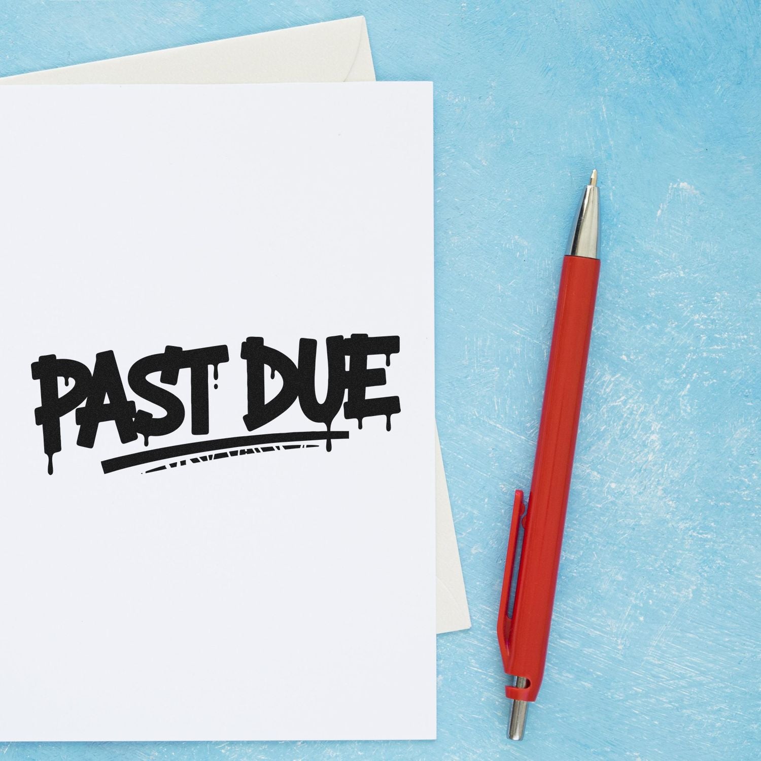 Black PAST DUE rubber stamp on white paper beside a red pen, set against a light blue background.