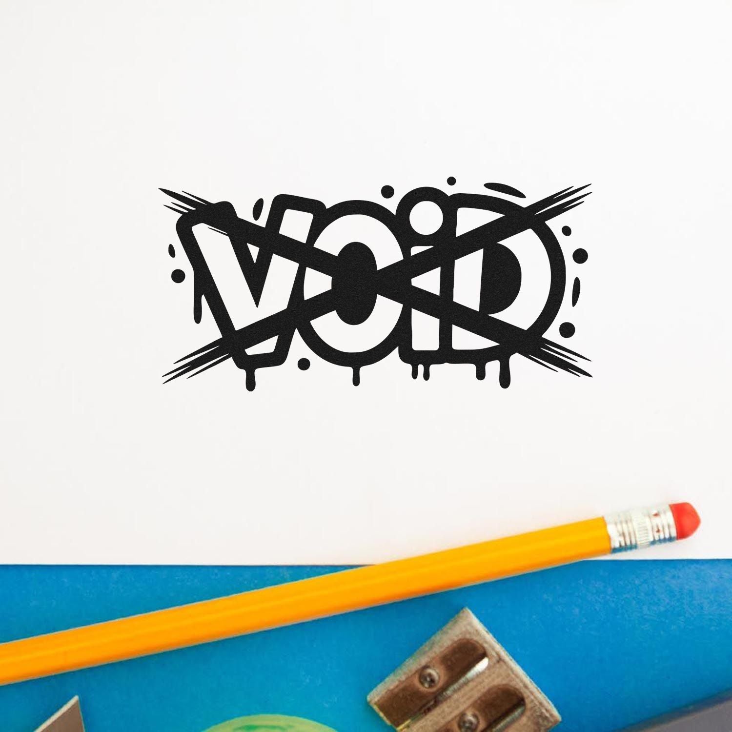 Black VOID stamp seal with graffiti-style lettering on white paper, beside a yellow pencil on a blue desk.