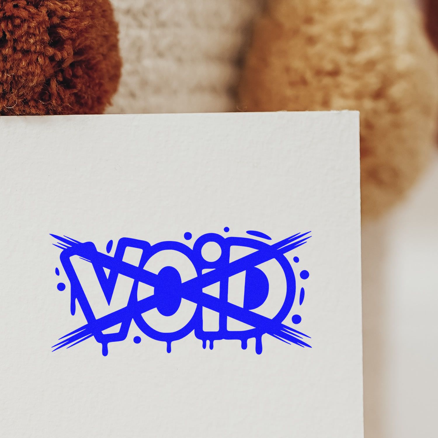 White paper card with bold blue VOID stamp seal, graffiti-style crossed-out lettering and drips.