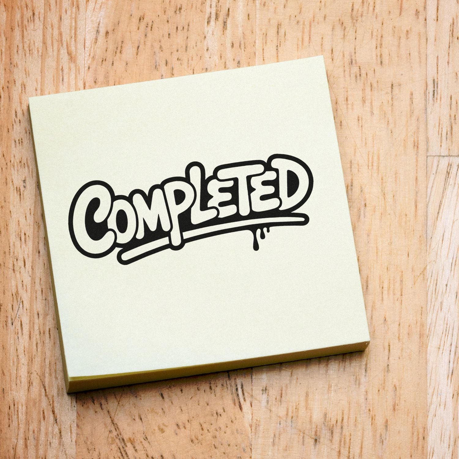 Cream notepad with black COMPLETED stamp-style seal on a light wood background.