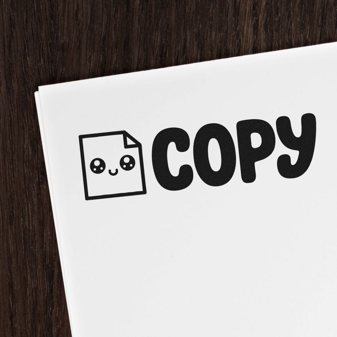 Black COPY stamp seal with cute document icon on white paper, placed on a dark wood background.