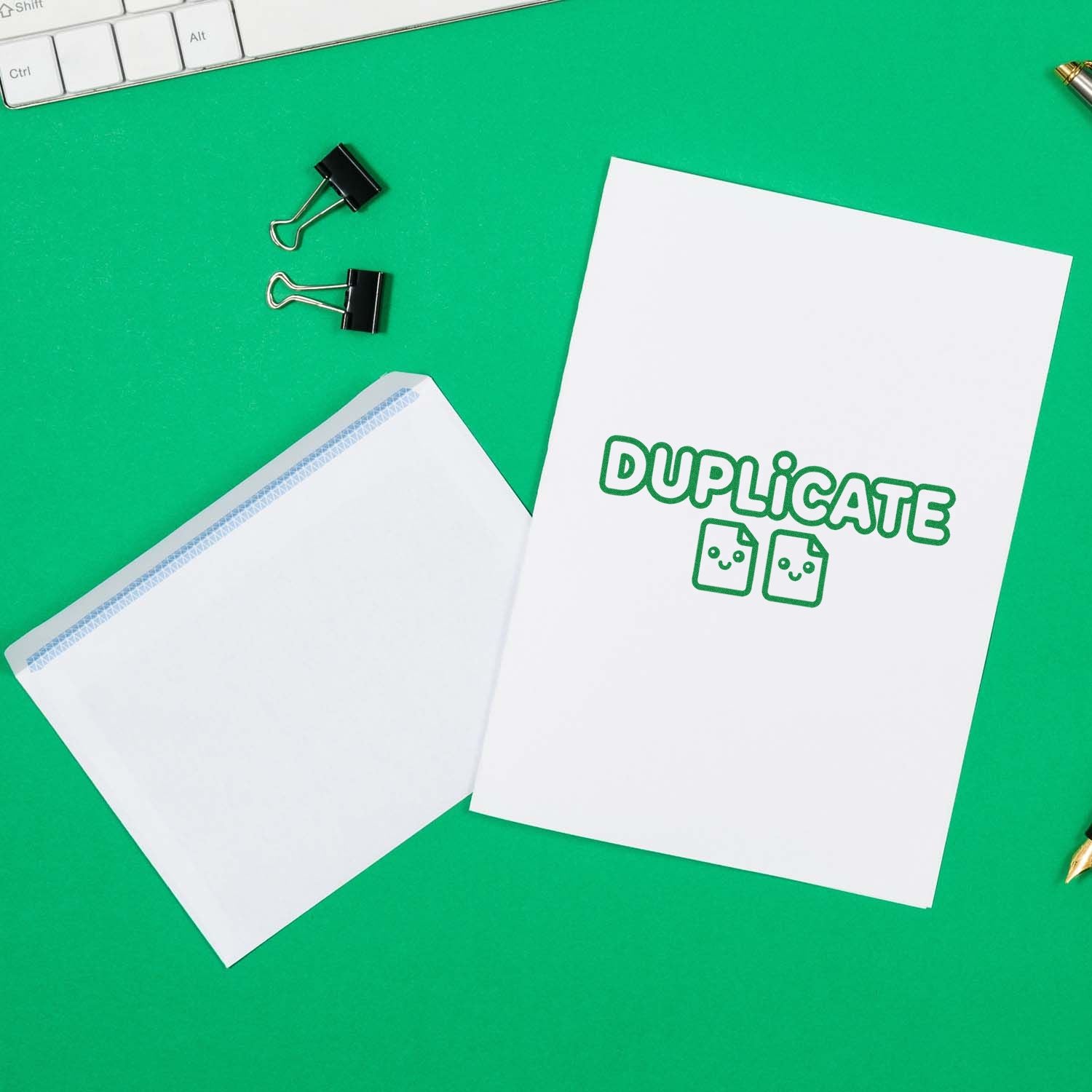 White duplicate stamp-and-seal sheets on a bright green desk with black binder clips and a white envelope.