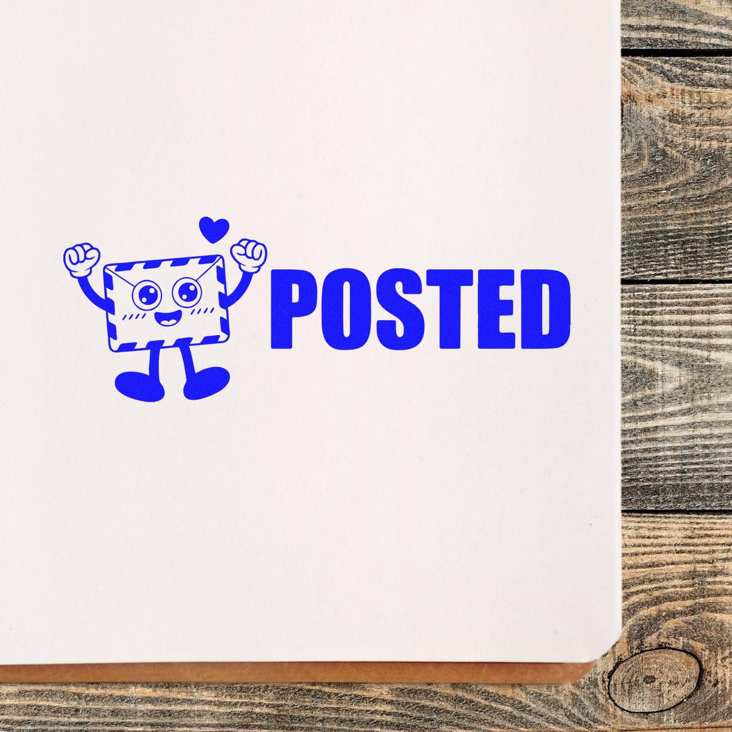 Blue POSTED stamp and seal with smiling envelope mascot and heart on white paper over rustic wood.