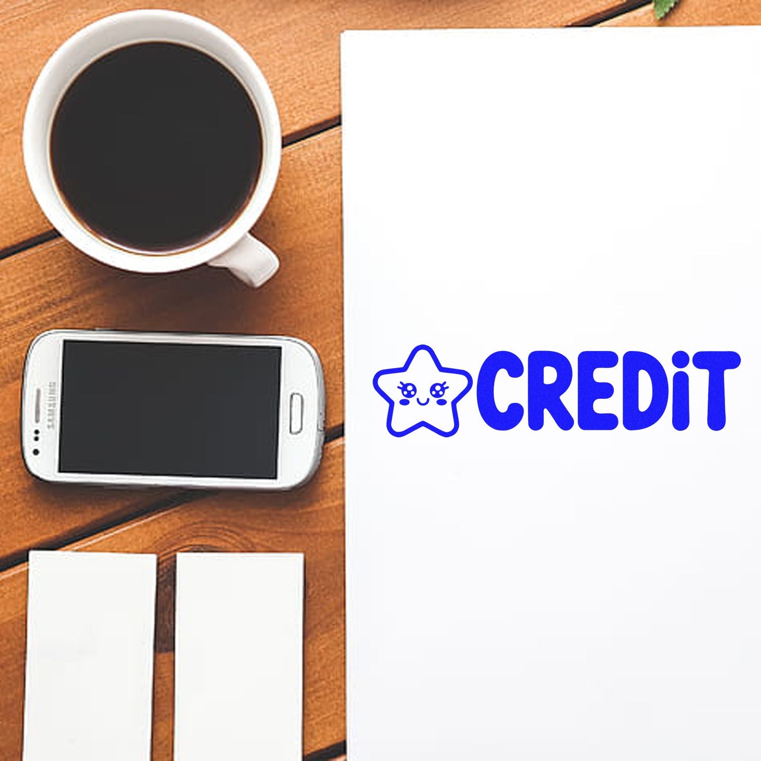 Blue CREDIT stamp and seal with star mascot on white paper beside coffee cup, smartphone, and blank cards