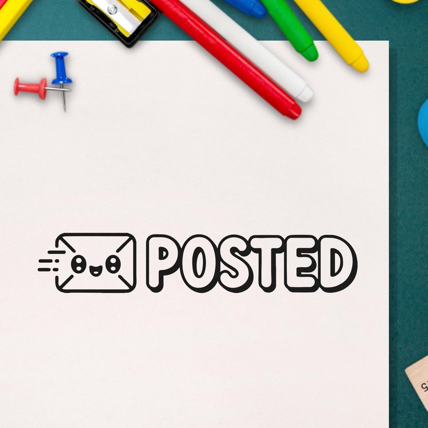 Black POSTED stamp with envelope icon on white paper, framed by colorful pens, pushpins, and a teal background.
