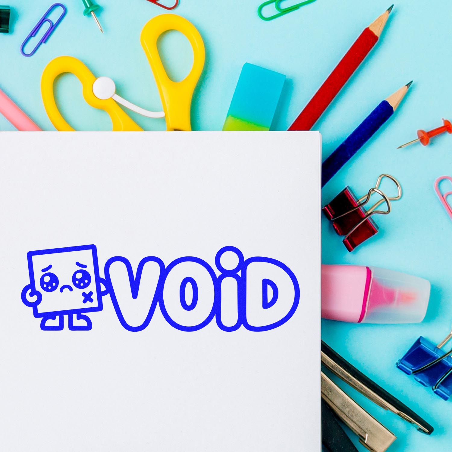 Blue VOID stamp seal on white paper, surrounded by colorful stationery, yellow scissors, pencils, and binder clips on aqua background.