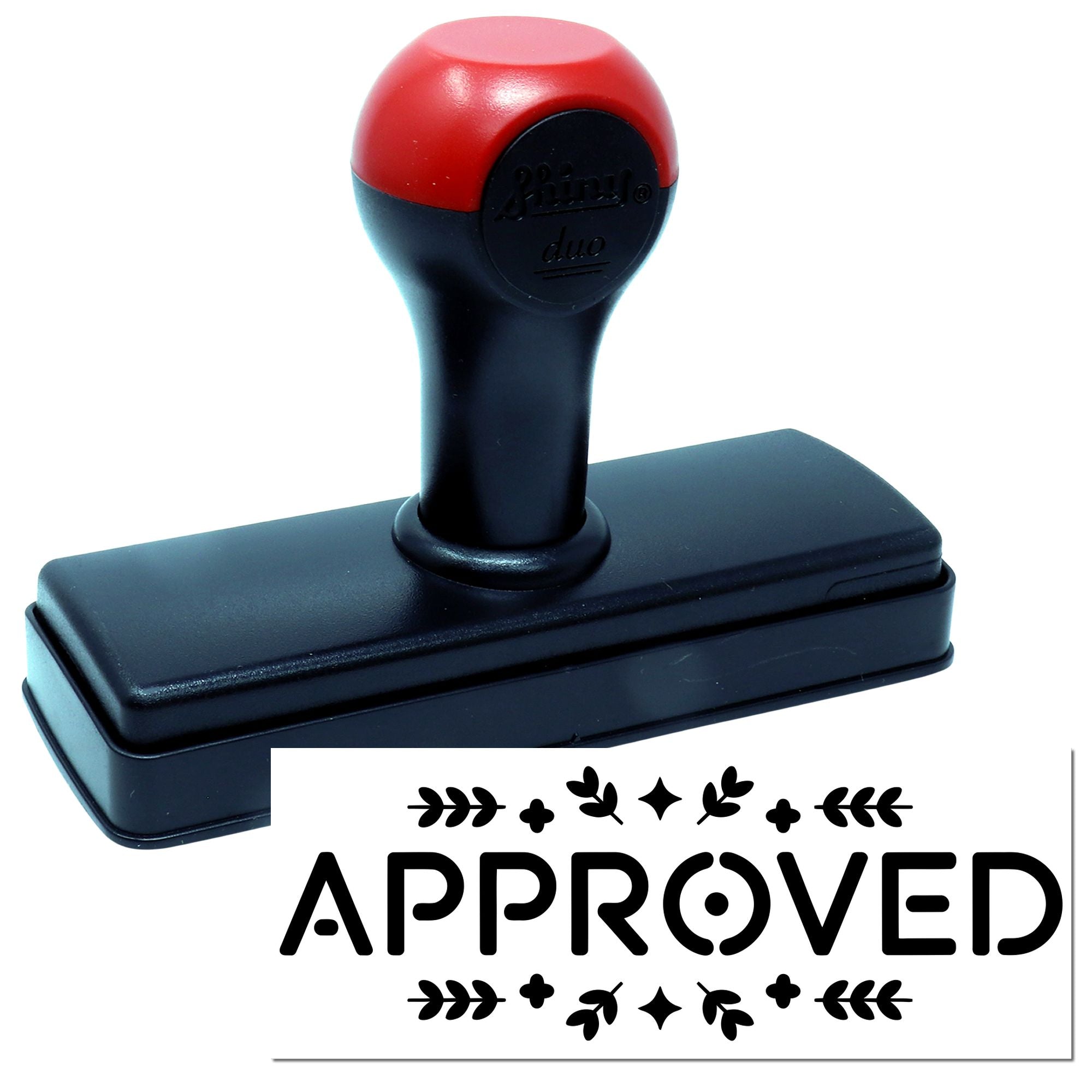 Red-and-black self-inking rubber stamp with APPROVED seal and decorative leaf border.