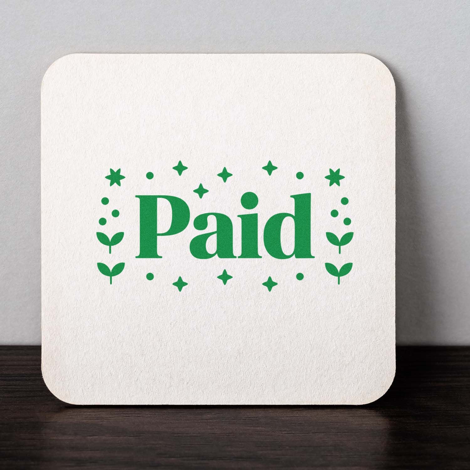 Green Paid stamp seal on a white square card with star and leaf accents.