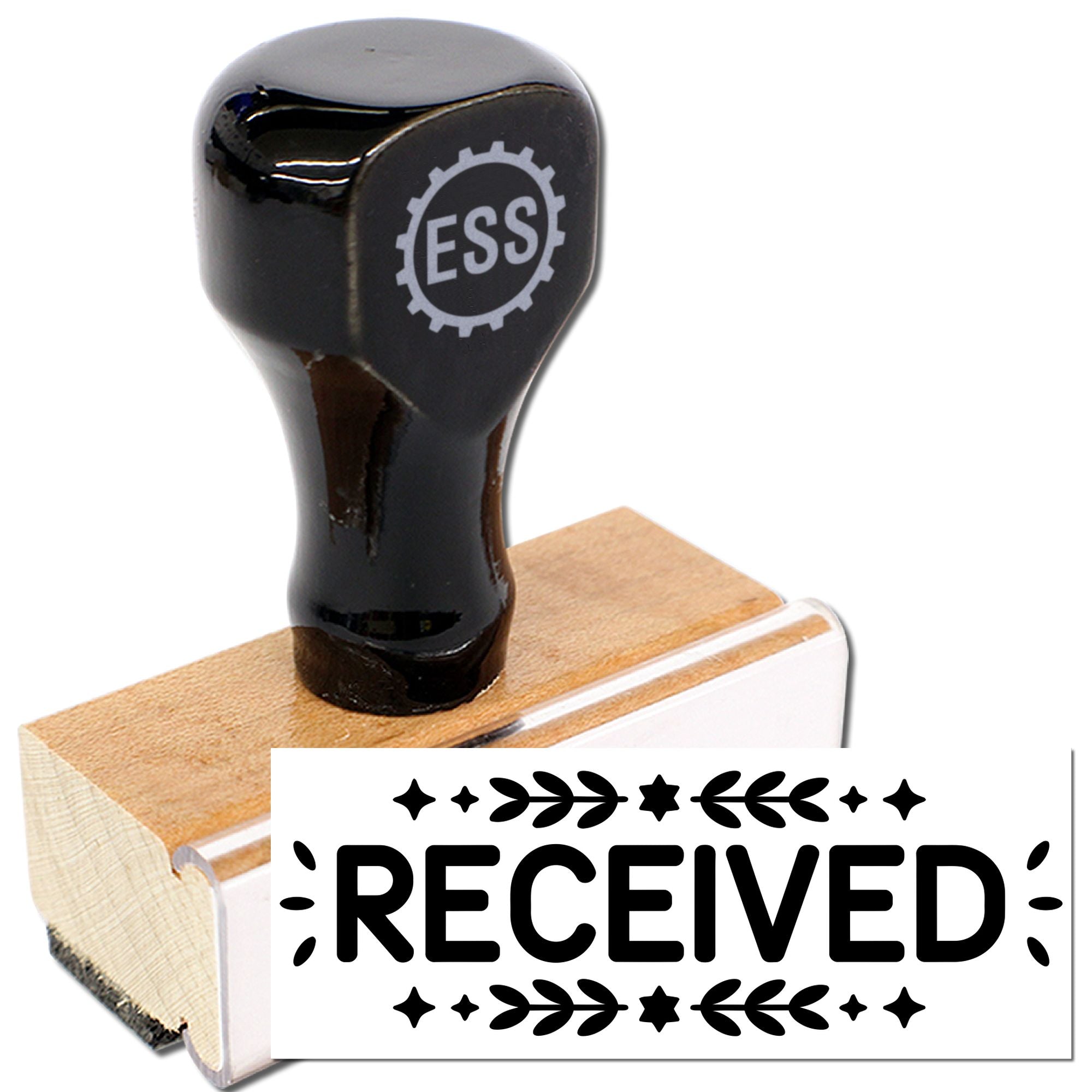 Black rubber stamp and seal with wooden base, printing bold RECEIVED in black with decorative leaves and stars.