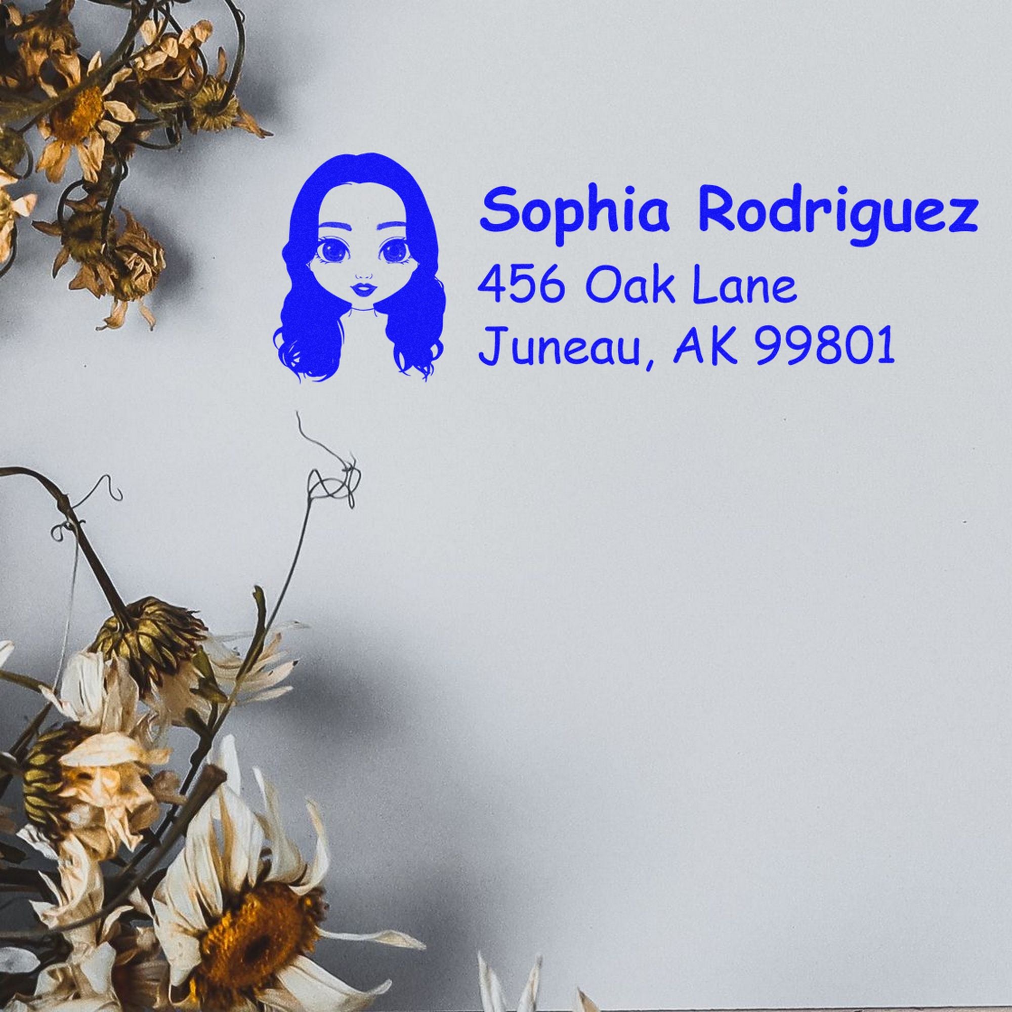 Blue custom address stamp and seal with cartoon girl, Sophia Rodriguez, 456 Oak Lane, Juneau, AK 99801 on white background