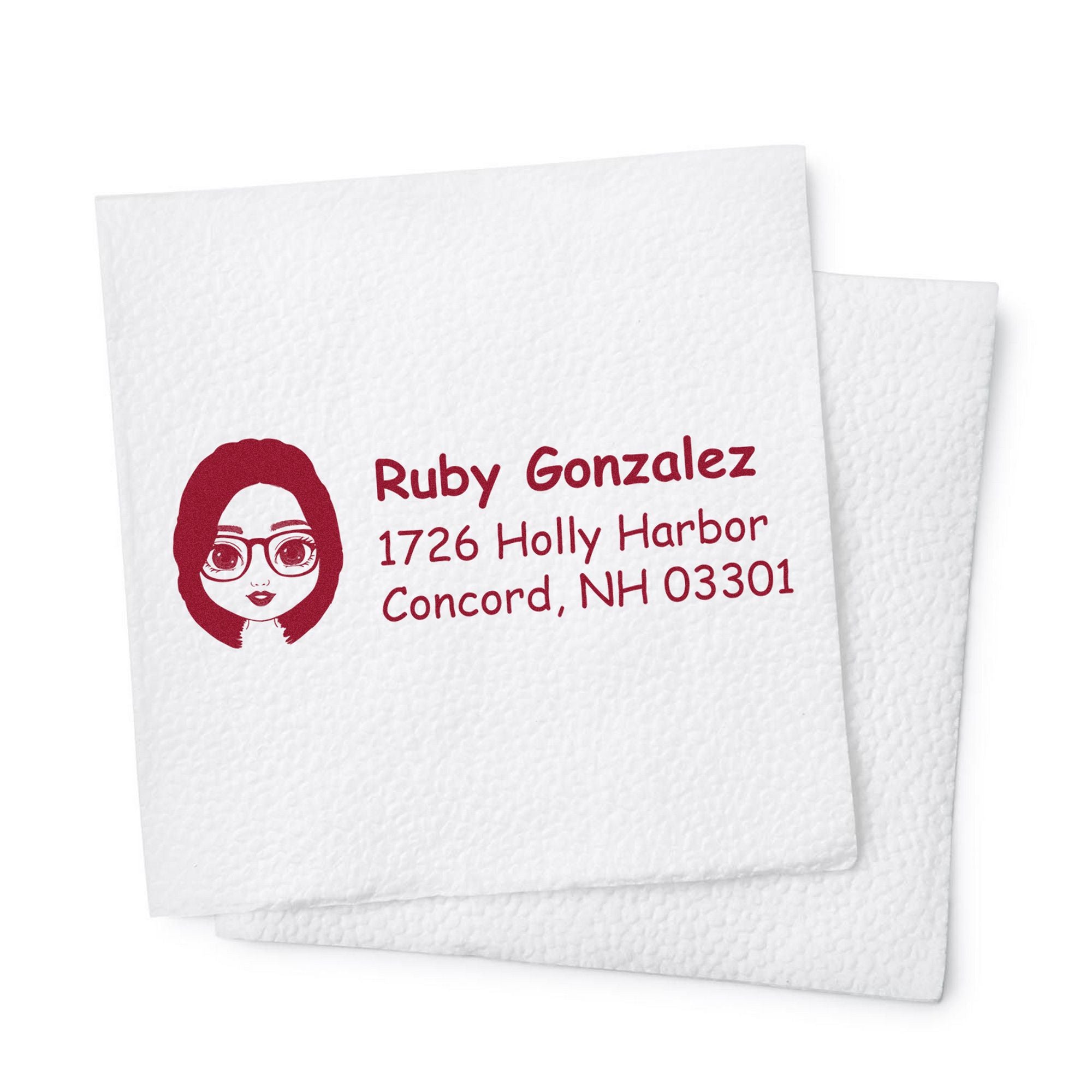 Burgundy personalized stamp seal with cartoon face, name and address on textured white paper.