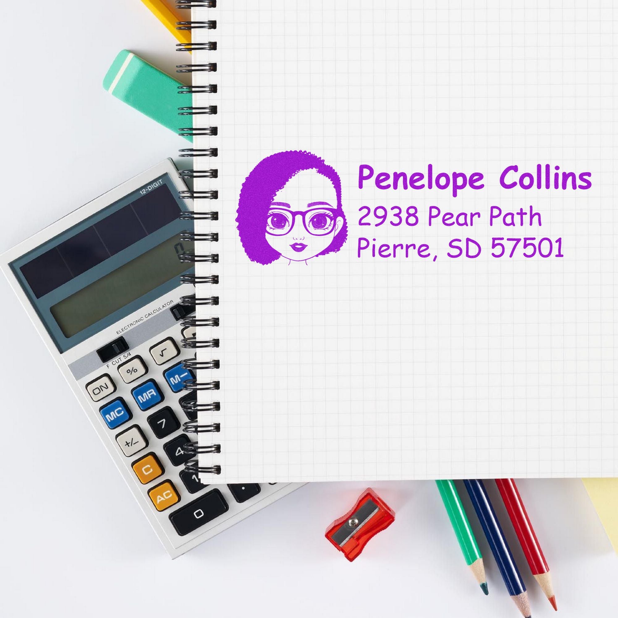 Purple custom address stamp for Penelope Collins, 2938 Pear Path, Pierre, SD 57501 on a notebook with calculator and pencils.