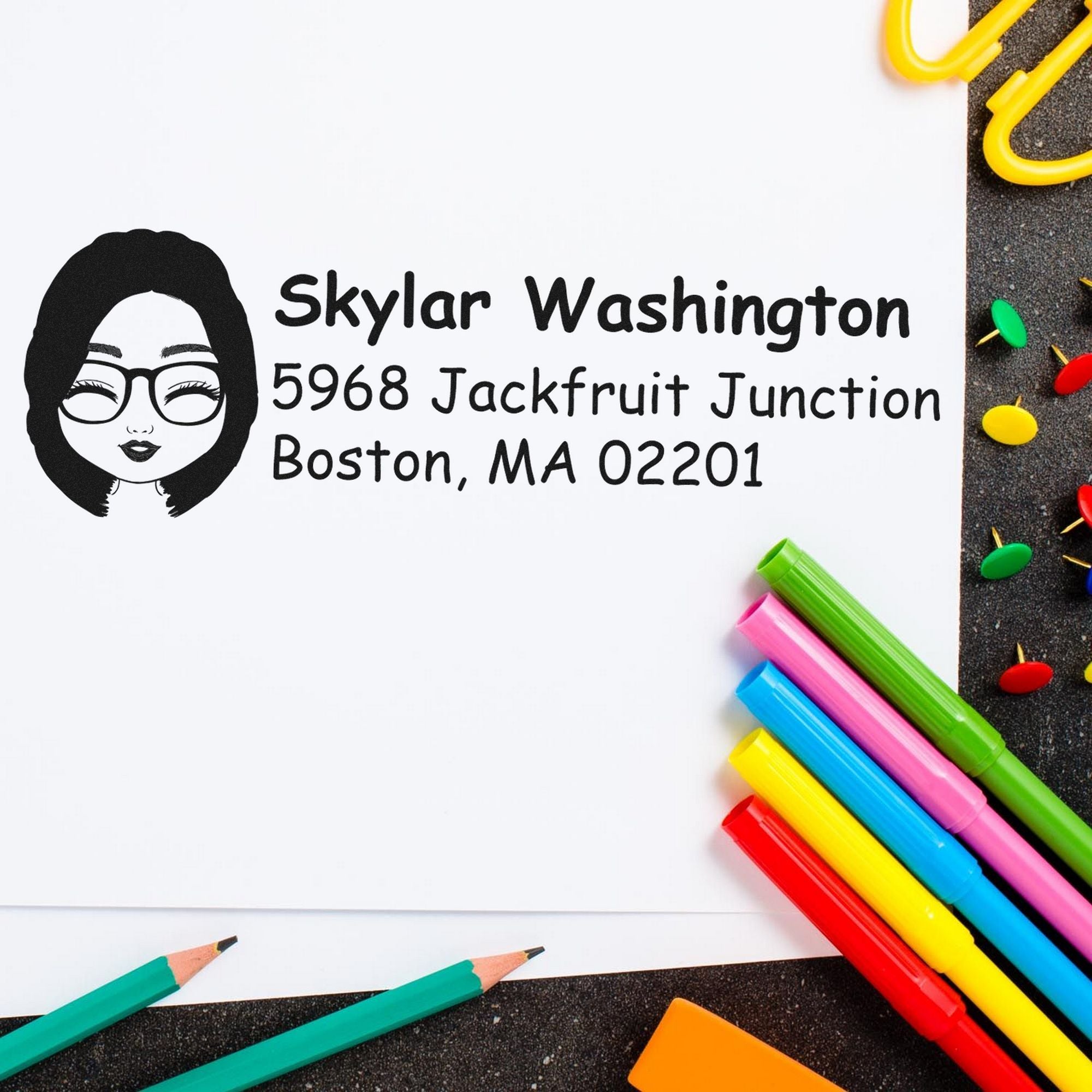 Custom black self-inking stamp and seal for Skylar Washington with woman icon, on white paper beside bright markers.