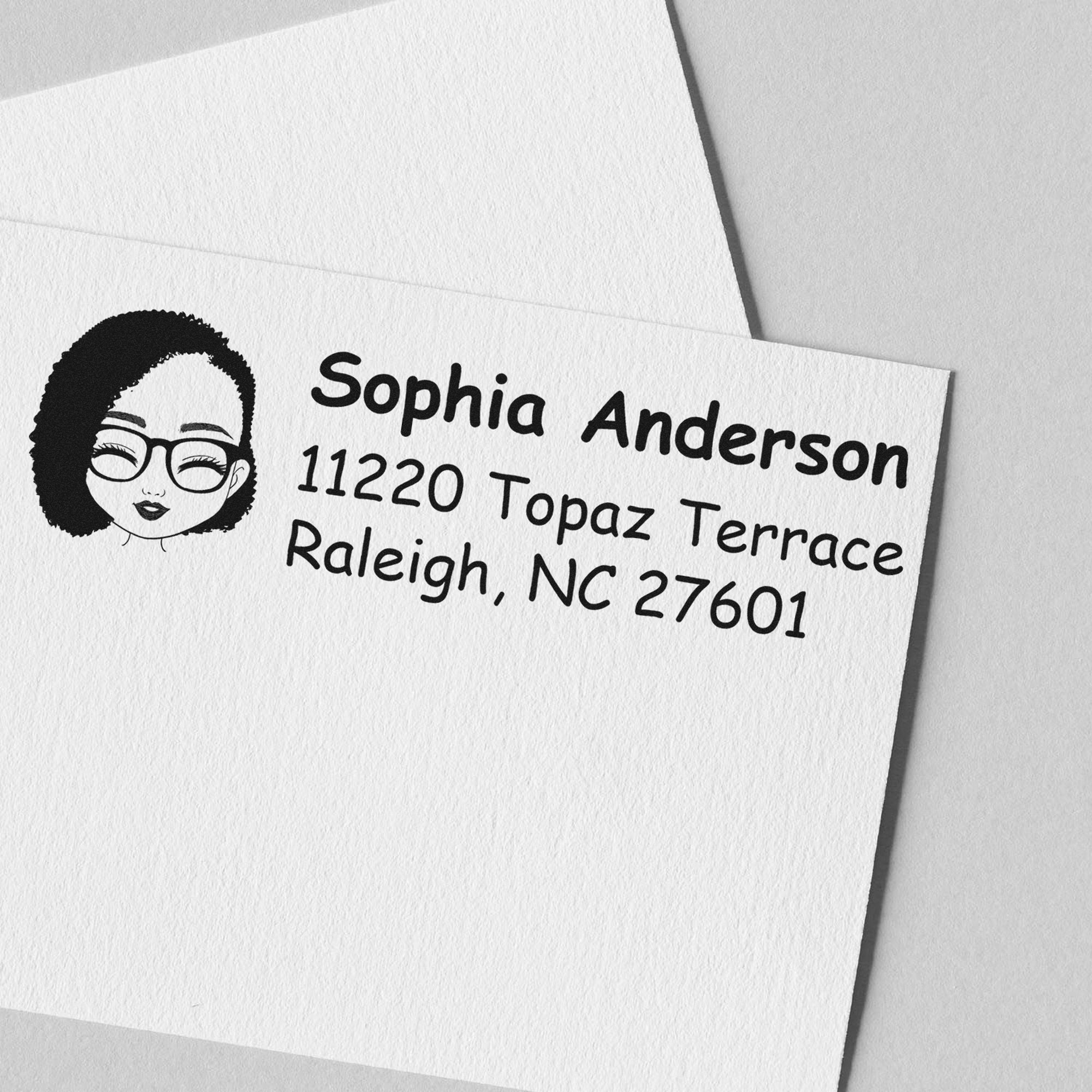 Black custom address stamp and seal with illustrated woman, Sophia Anderson, Raleigh NC 27601 on white textured paper