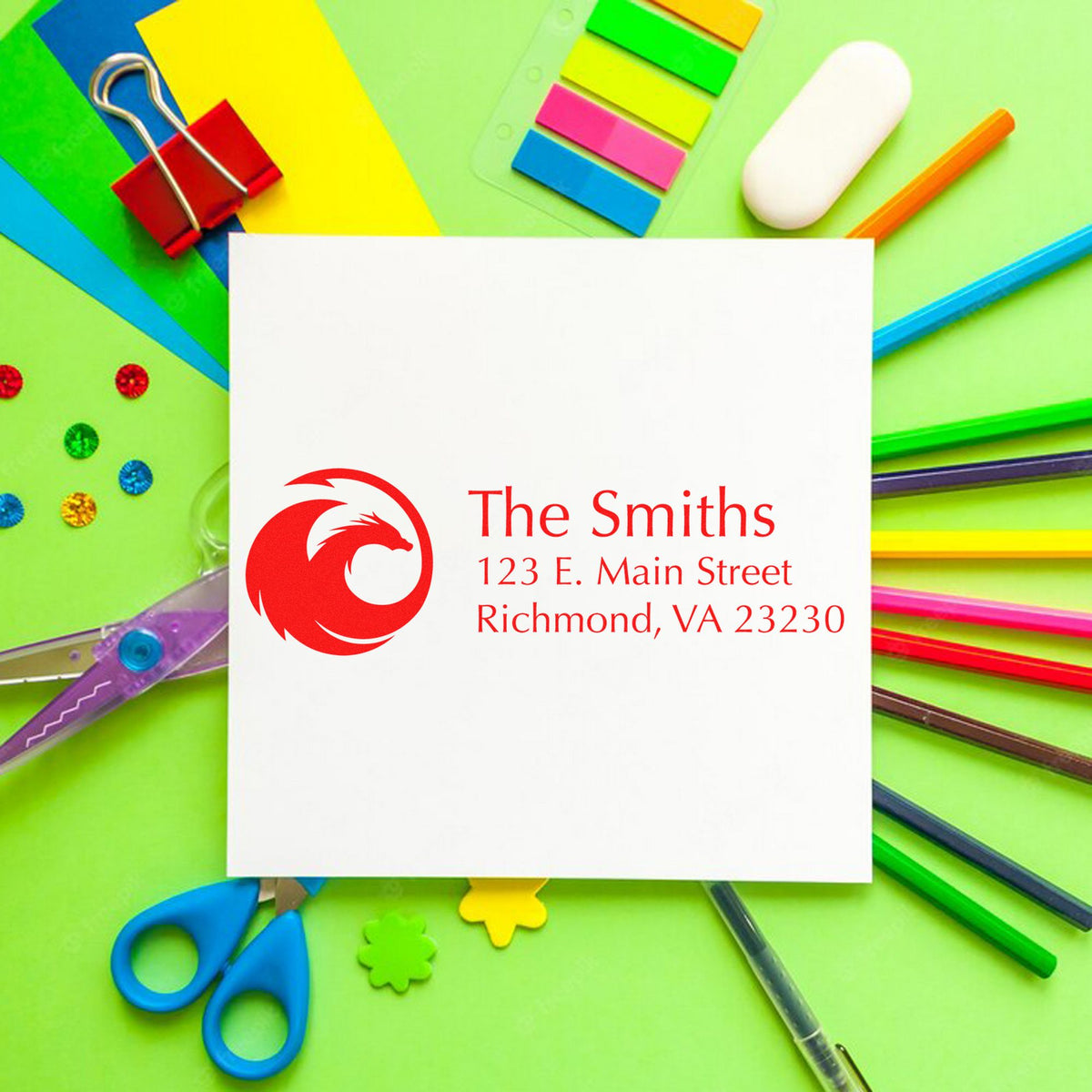White custom return address stamp with red dragon seal and The Smiths address, on a bright green background with colorful stationery.