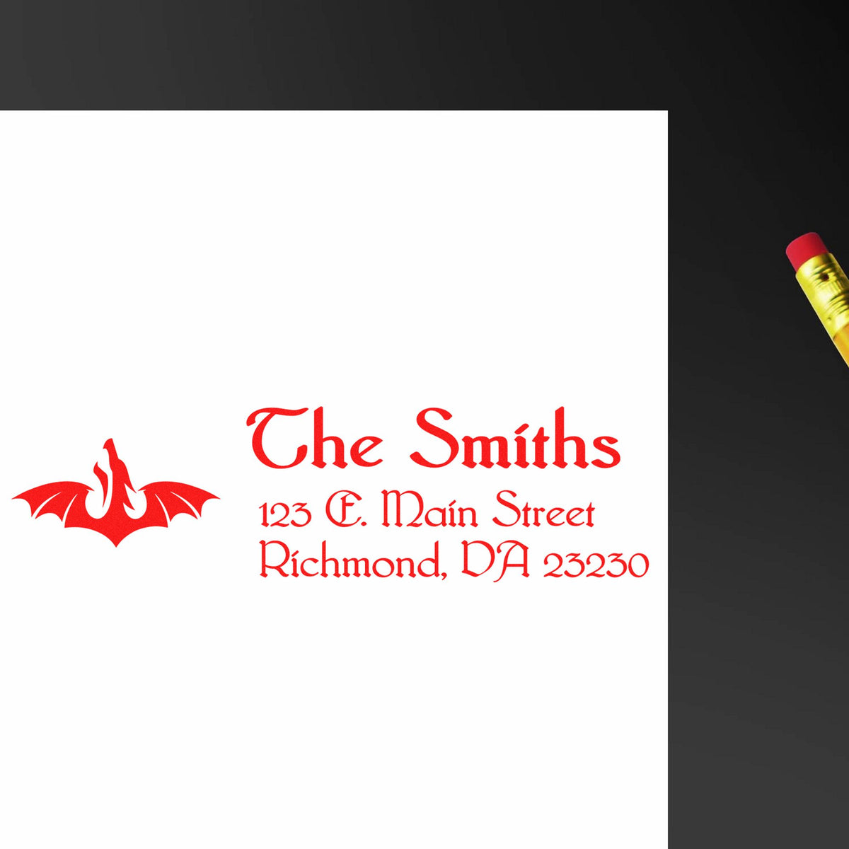 Red custom stamp and seal for The Smiths with bat logo and address on white card, beside a yellow pencil on black.