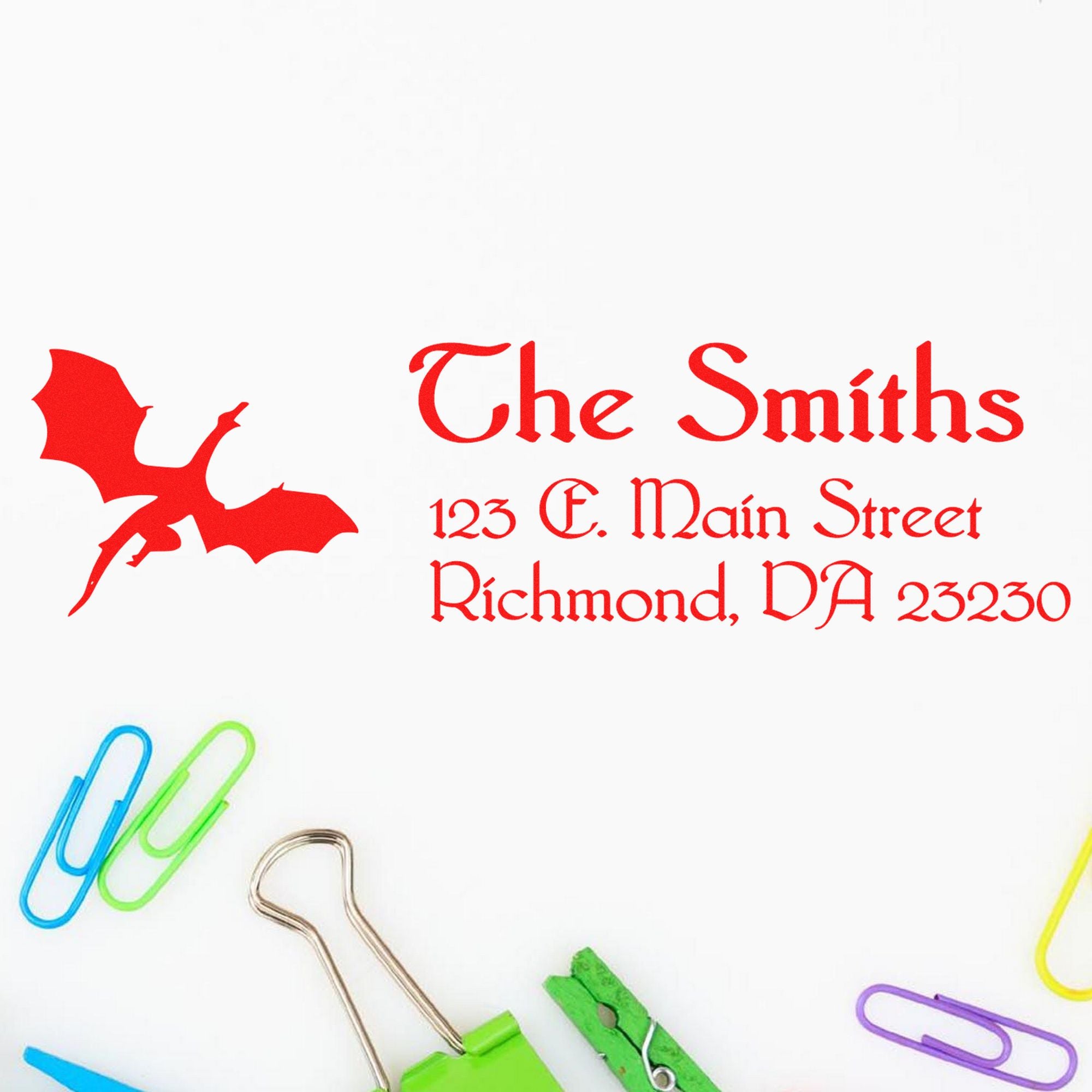 Red custom business stamp and seal for The Smiths with dragon logo, address text, and colorful paper clips on white background