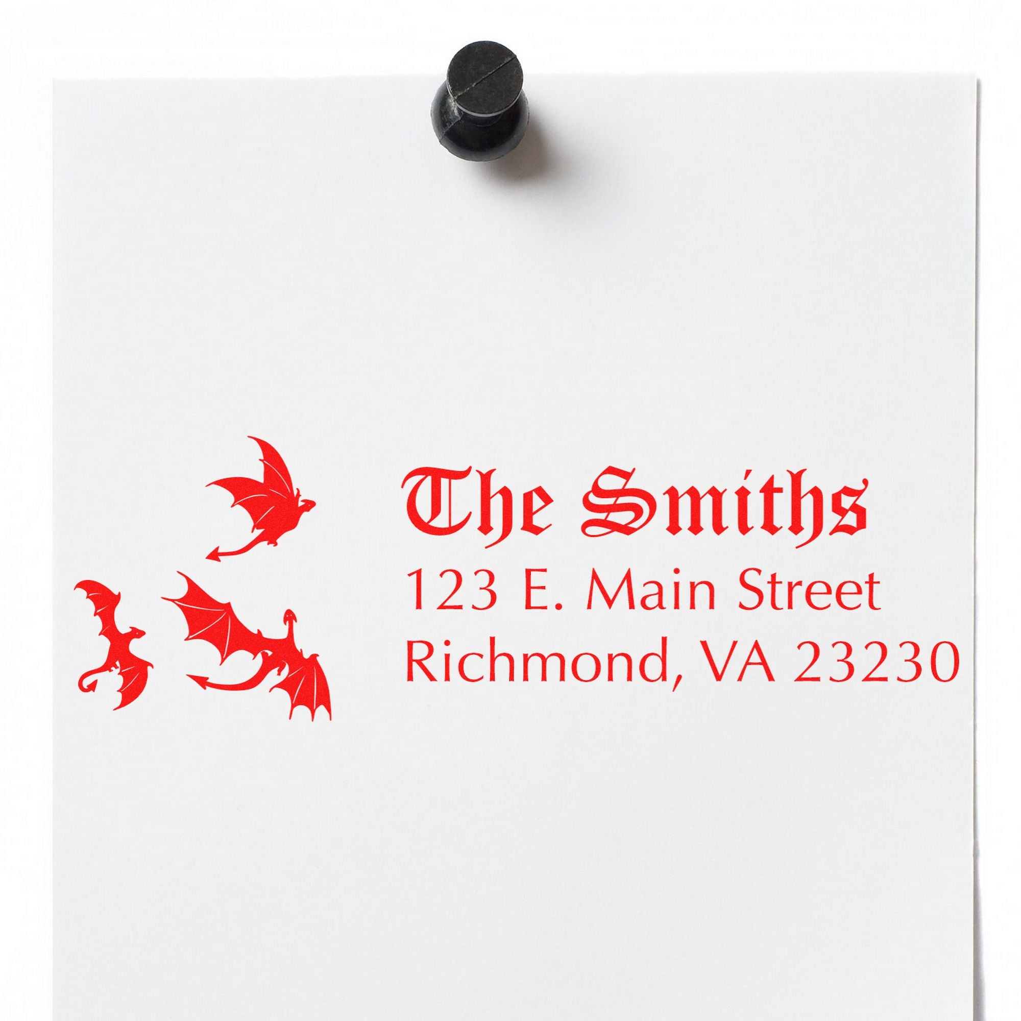 Black wax seal stamp on white paper with red gothic The Smiths address and dragon seal design.