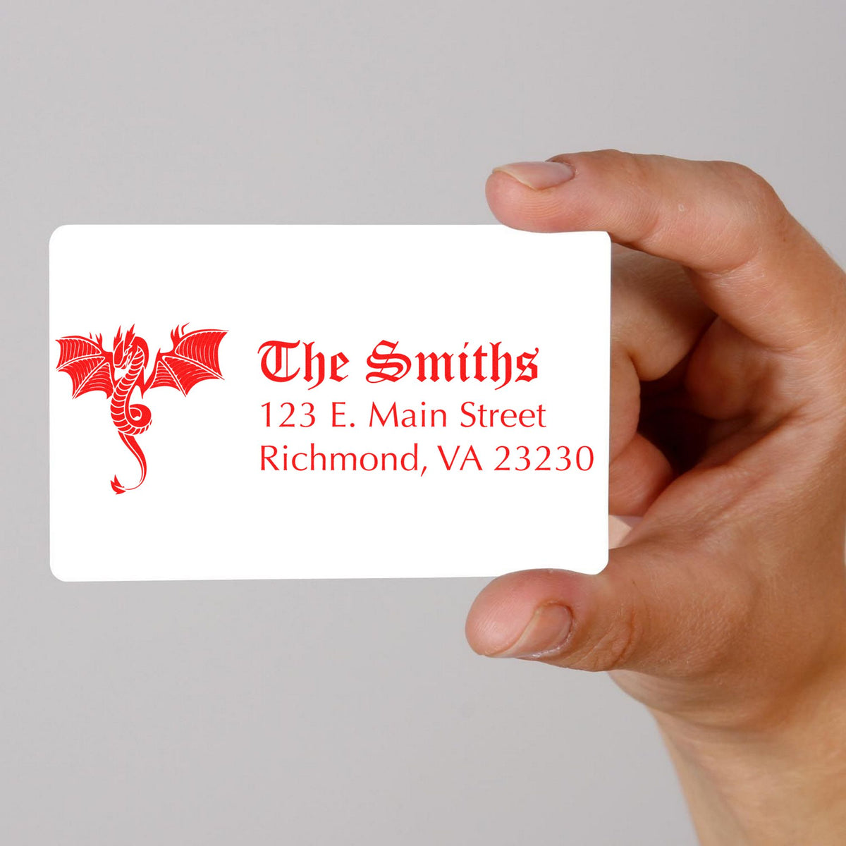 Hand holding white custom stamp card with red dragon seal, The Smiths, and Richmond, VA address.