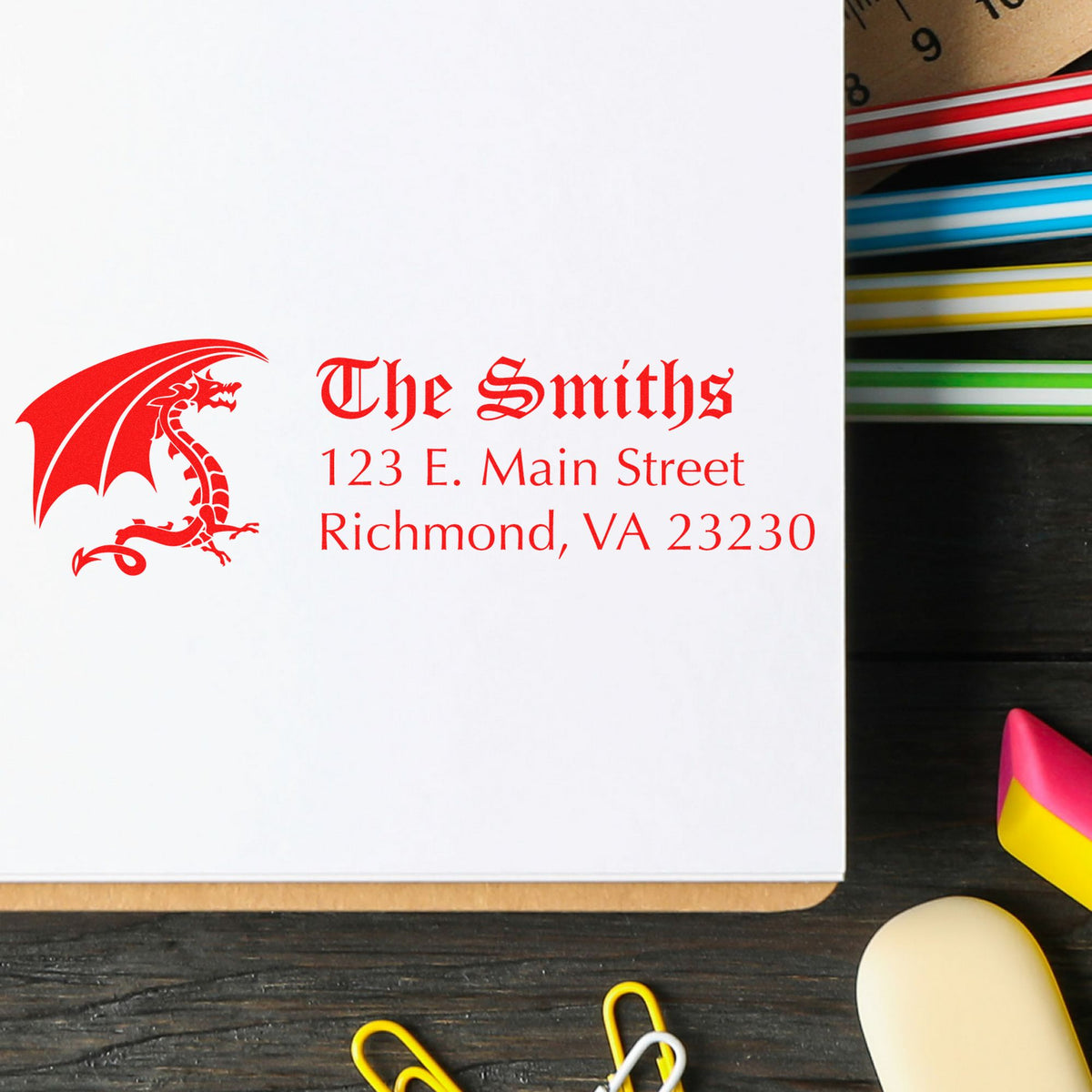 Red dragon custom address stamp on white paper with colorful seal tools and wax seal sticks.