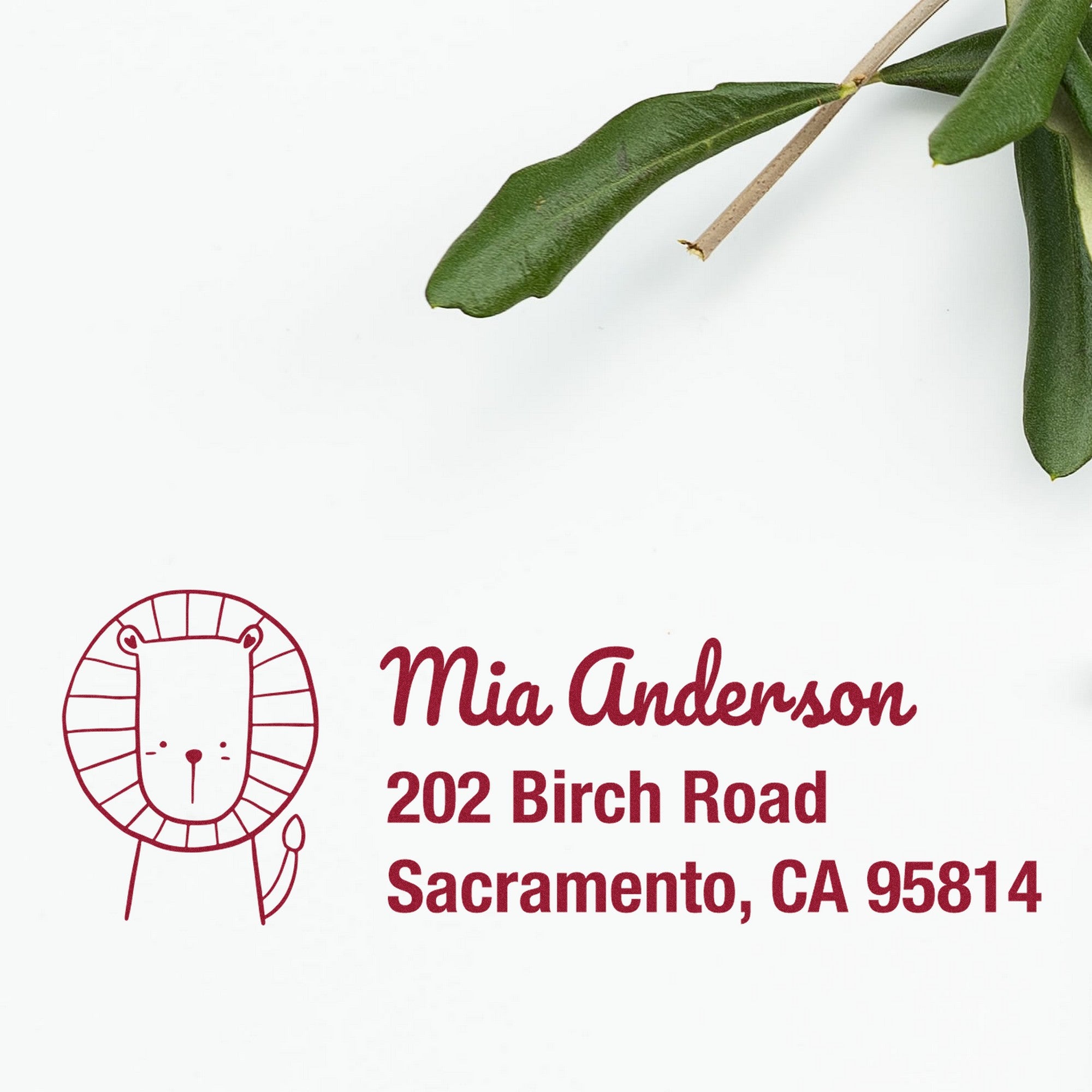 Little Roar Customize Mailing Address Self-Inking Stamp featuring a cute lion design and the text "Mia Anderson, 202 Birch Road, Sacramento, CA 95814." This Custom-Made Return Mail Stamp is shown on a white background with a green leaf accent.